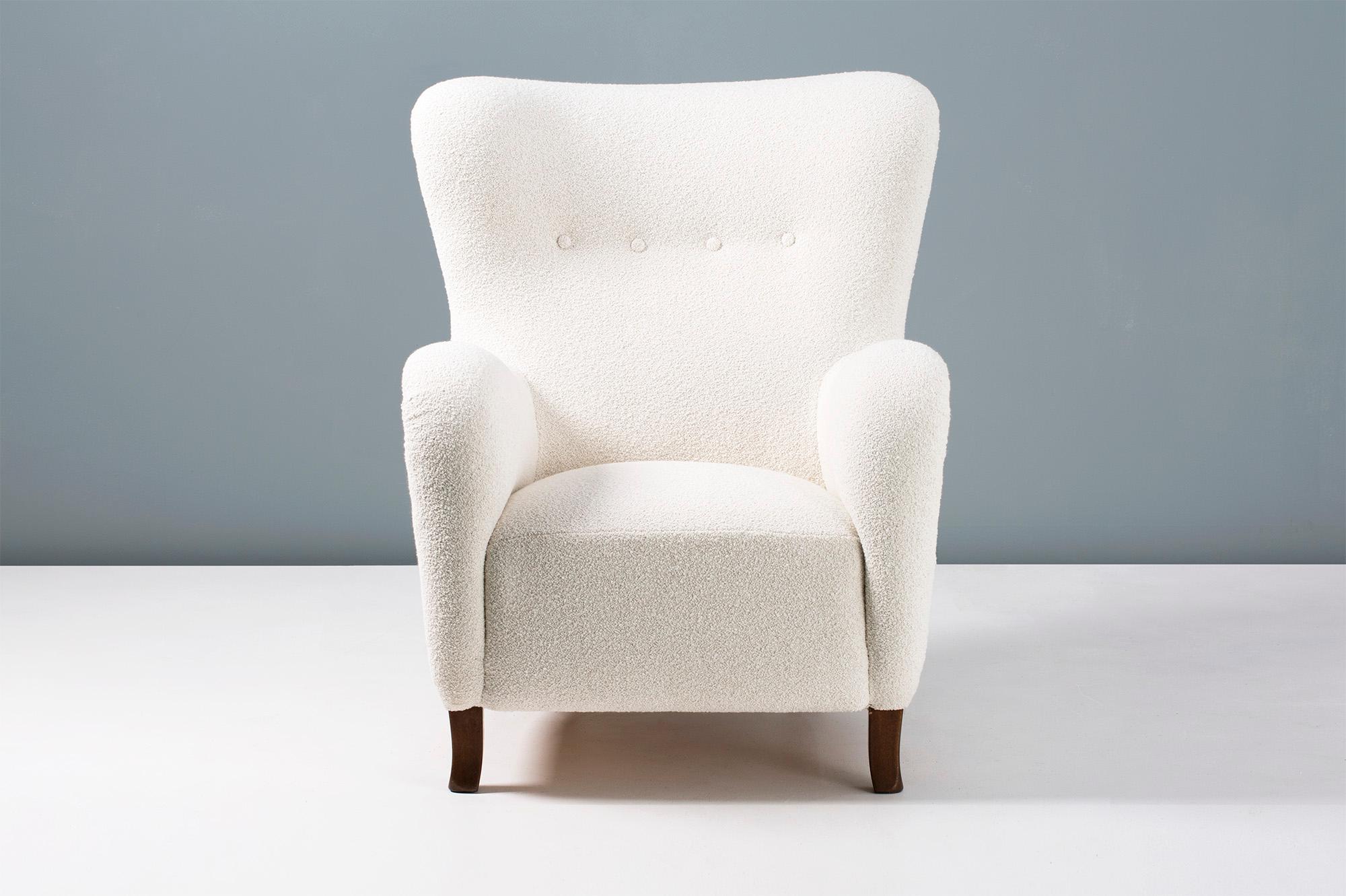 1940s vintage wing chair in the manner of Fritz Hansen, produced in Copenhagen by Christian Sorensen & Co. The legs are stained beechwood and the chair has been reupholstered in luxurious bouclé fabric composed of cotton and wool.

Pair available