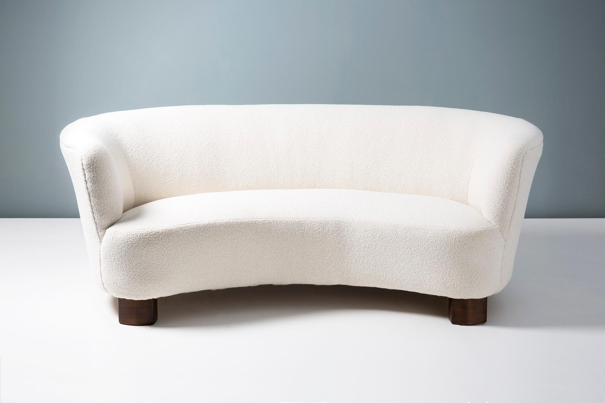 Danish cabinetmaker

Curved sofa, 1940s.

Curved sofa produced in Denmark in the 1940s. The sofa has thick, stained beech wood legs and has been reupholstered in cotton-wool blend bouclé fabric from Chase Erwin in the UK. The sofa has been