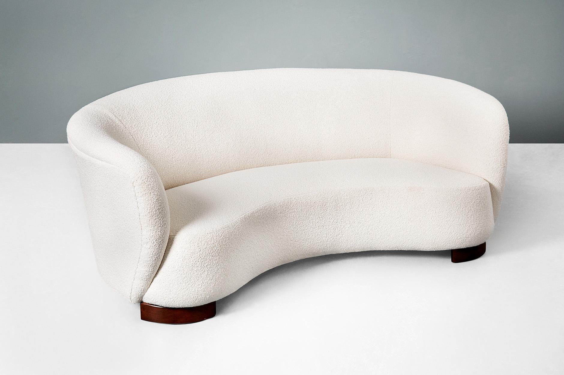 Danish cabinetmaker

Curved sofa, 1940s.

Curved sofa produced in Denmark in the 1940s. The sofa has thick, stained beechwood legs and has been reupholstered in cotton-wool blend bouclé fabric from Chase Erwin in the UK. The sofa has been