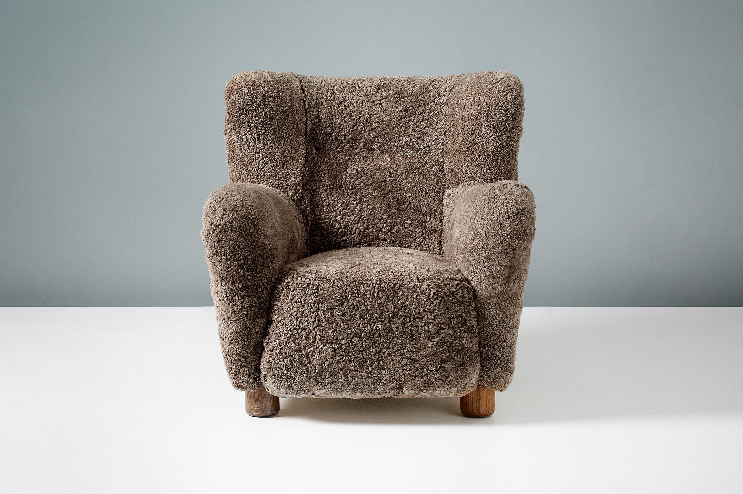 Large vintage armchair produced in Denmark sometime between 1940-1950. The legs are patented, oiled European oak and the chair has been completely reconditioned in our London workshop with new upholstery in luxurious 'Sahara' brown shearling from