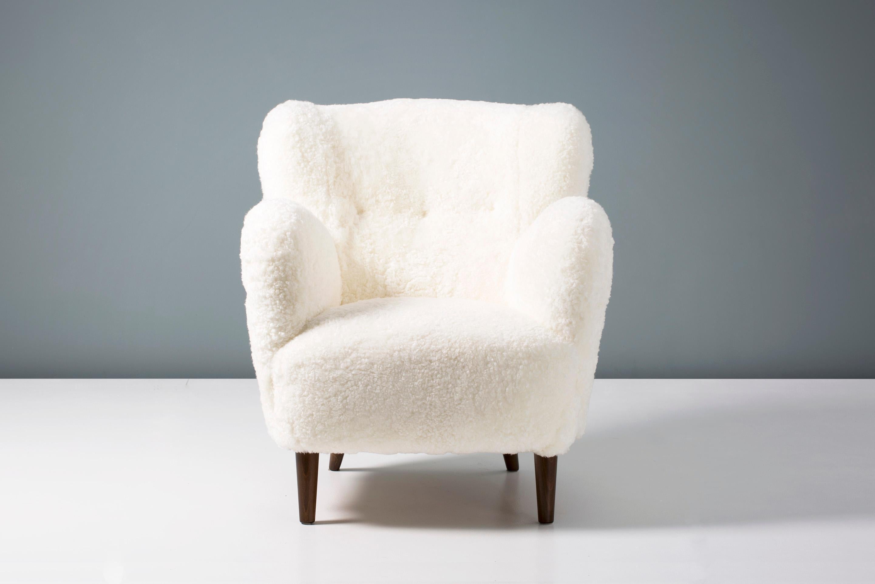 Danish cabinetmaker made lounge chair, circa 1950s.

Lounge chair produced in Denmark in the 1950s with tapered, stained beech legs and new off-white New Zealand sheepskin upholstery. 


