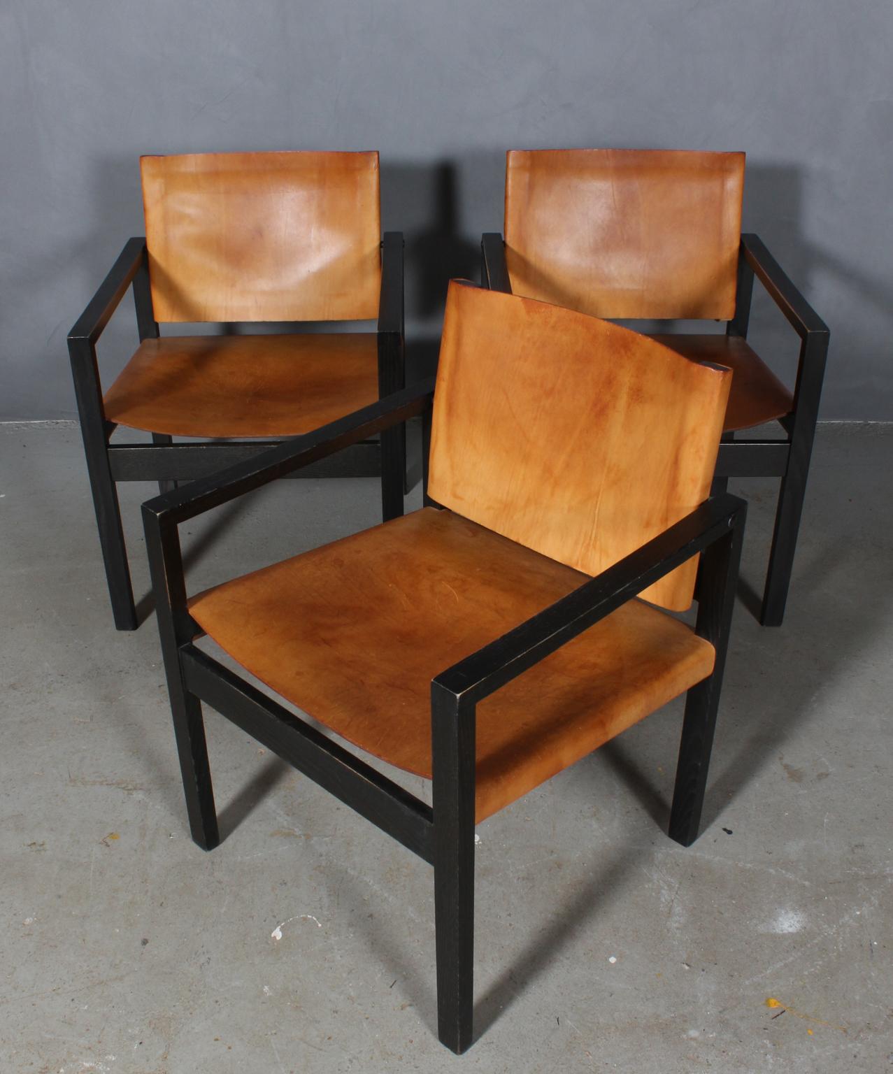 Danish cabinetmaker, armchairs with frame of black stained oak.

Seat and back of saddle leather.