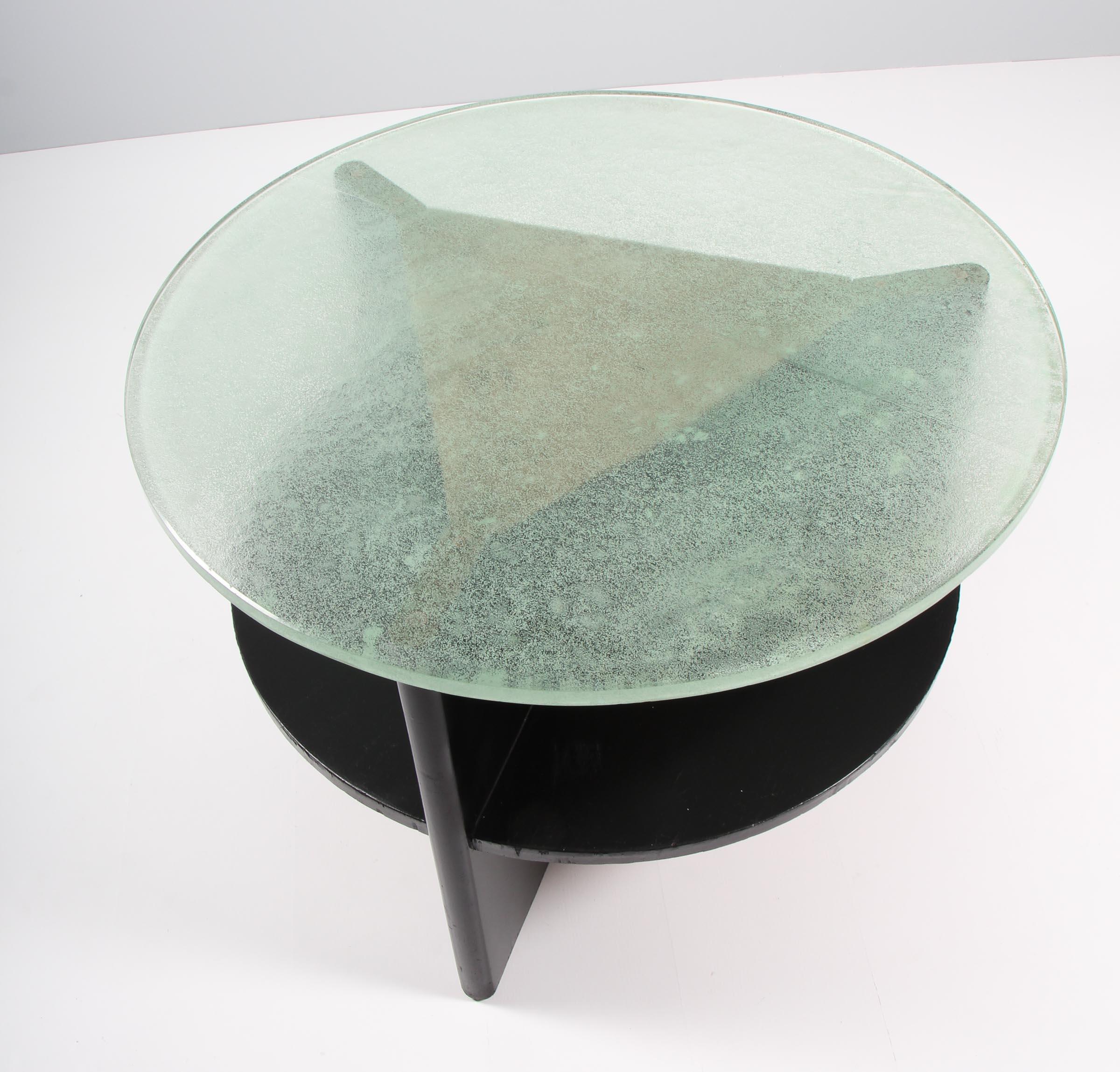 Danish cabinetmaker Art Deco coffee table with black laquered wooden frame.

Glass plate.

Made in the 1930s.