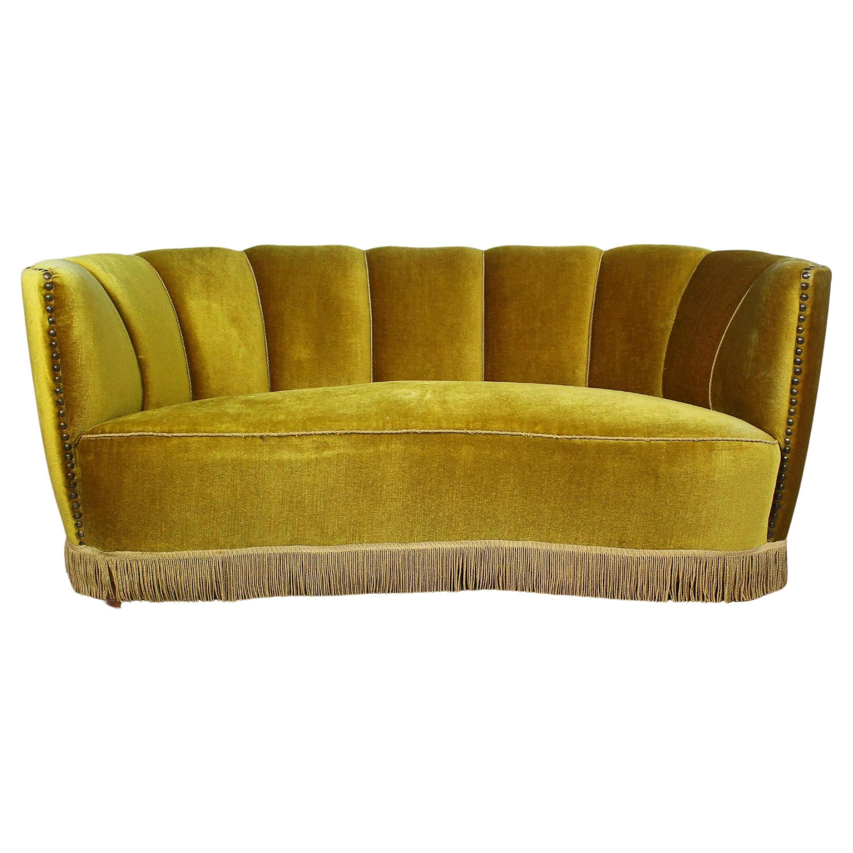 Banana shaped curved sofa from Mid-Century Modern era.
Made in Denmark, 1940s.
Upholstered in golden velvet.