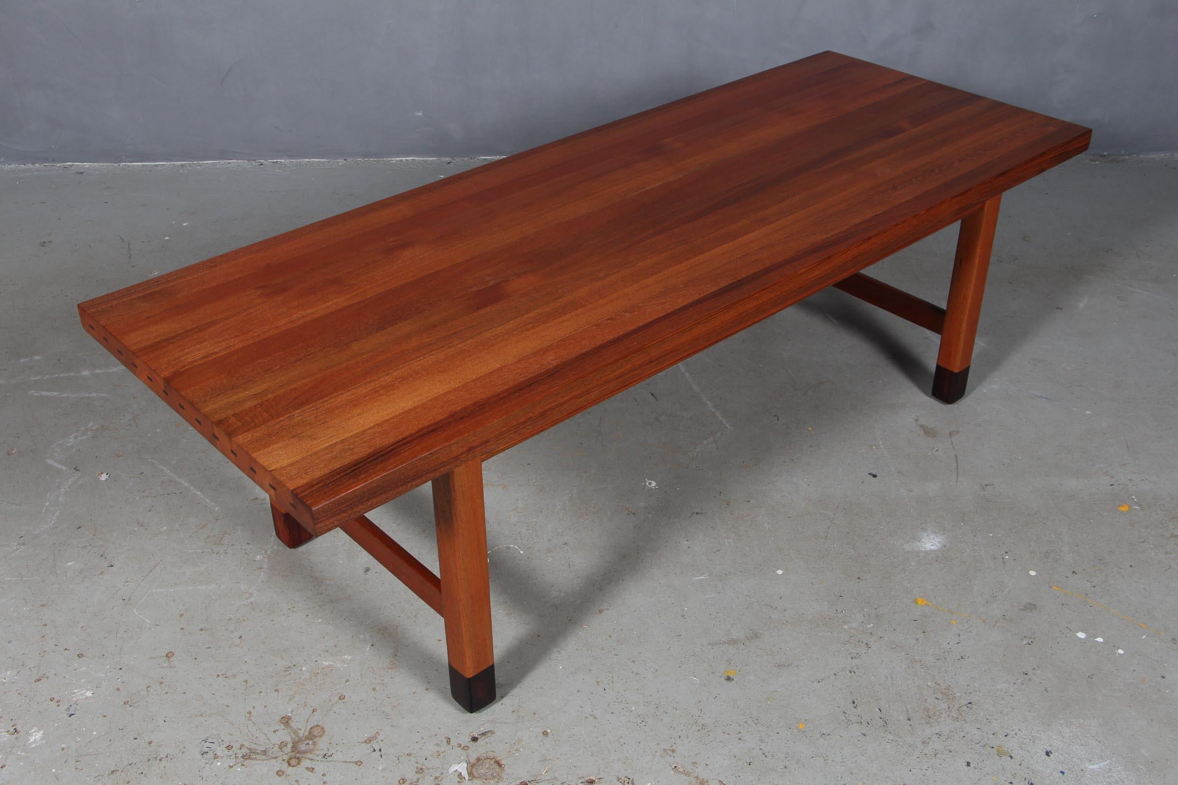 Danish cabinetmaker coffee table in solid teak with rosewood details.