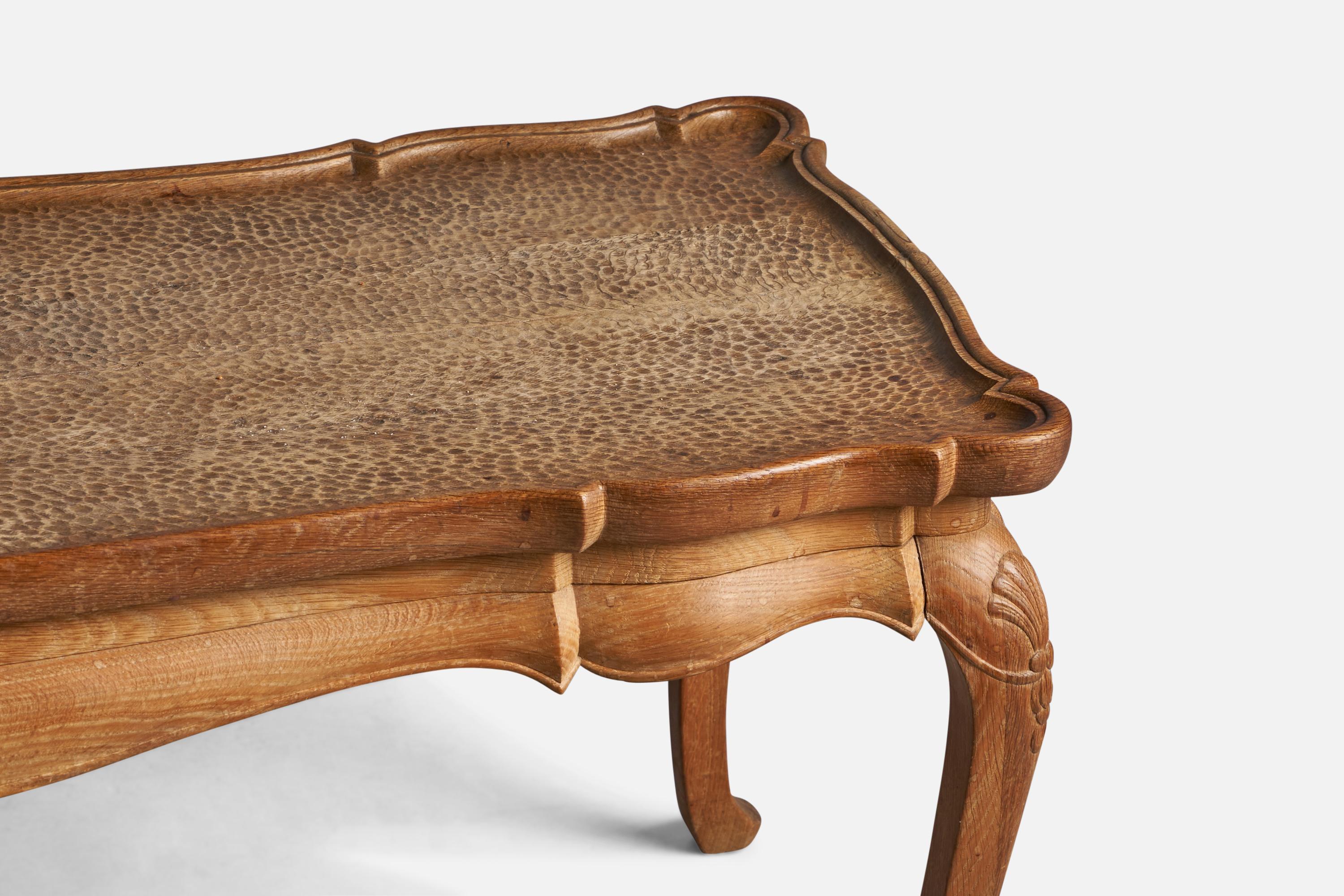 A carved solid oak coffee table, designed and produced in Denmark, 1930s.