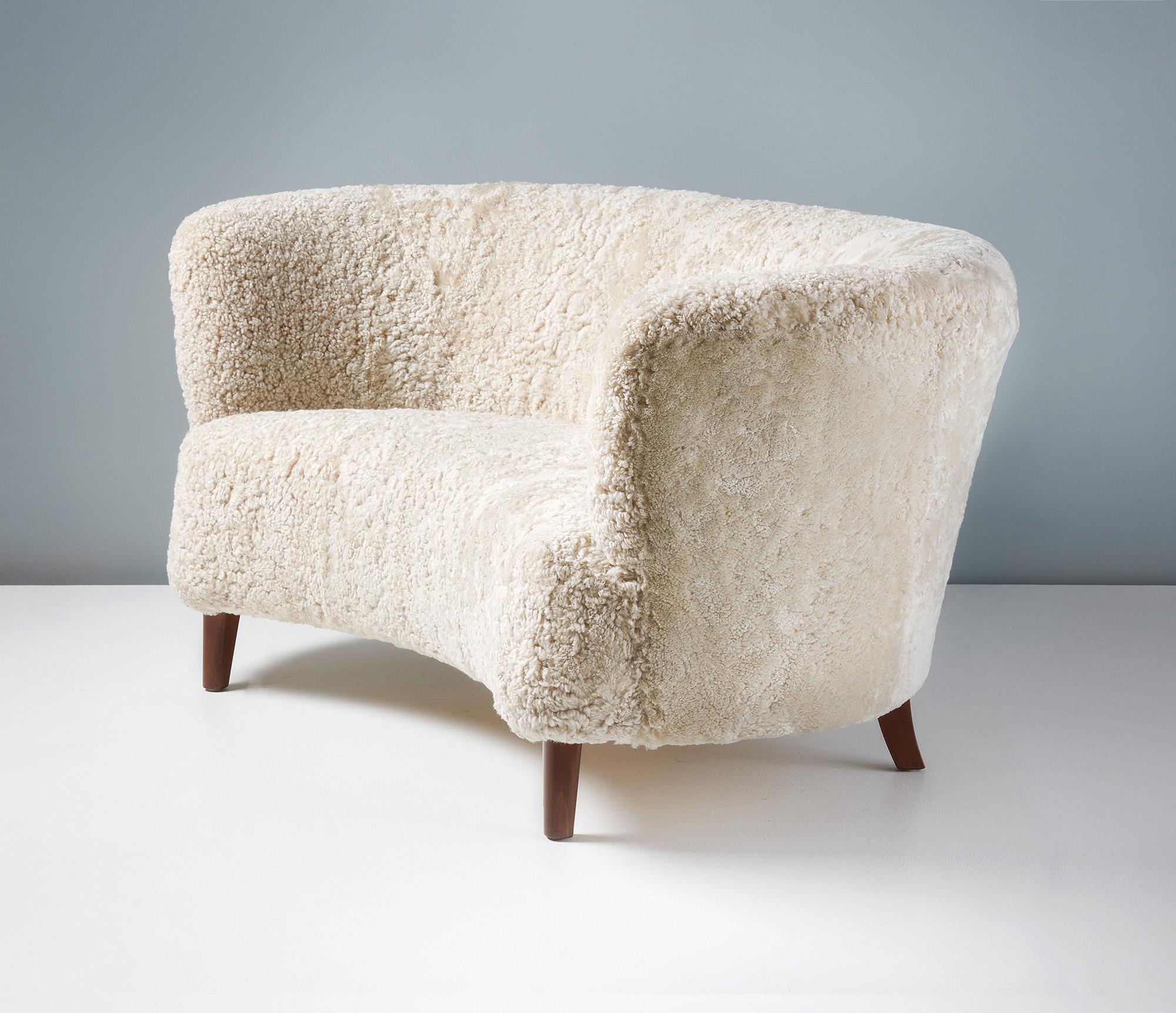 This wonderfully curved sofa, produced by a Danish Cabinetmaker in the 1940s, has an inviting back and wrap around arms. It also features a curved seat and has been totally refurbished at our London workshops with new padding and reupholstery in