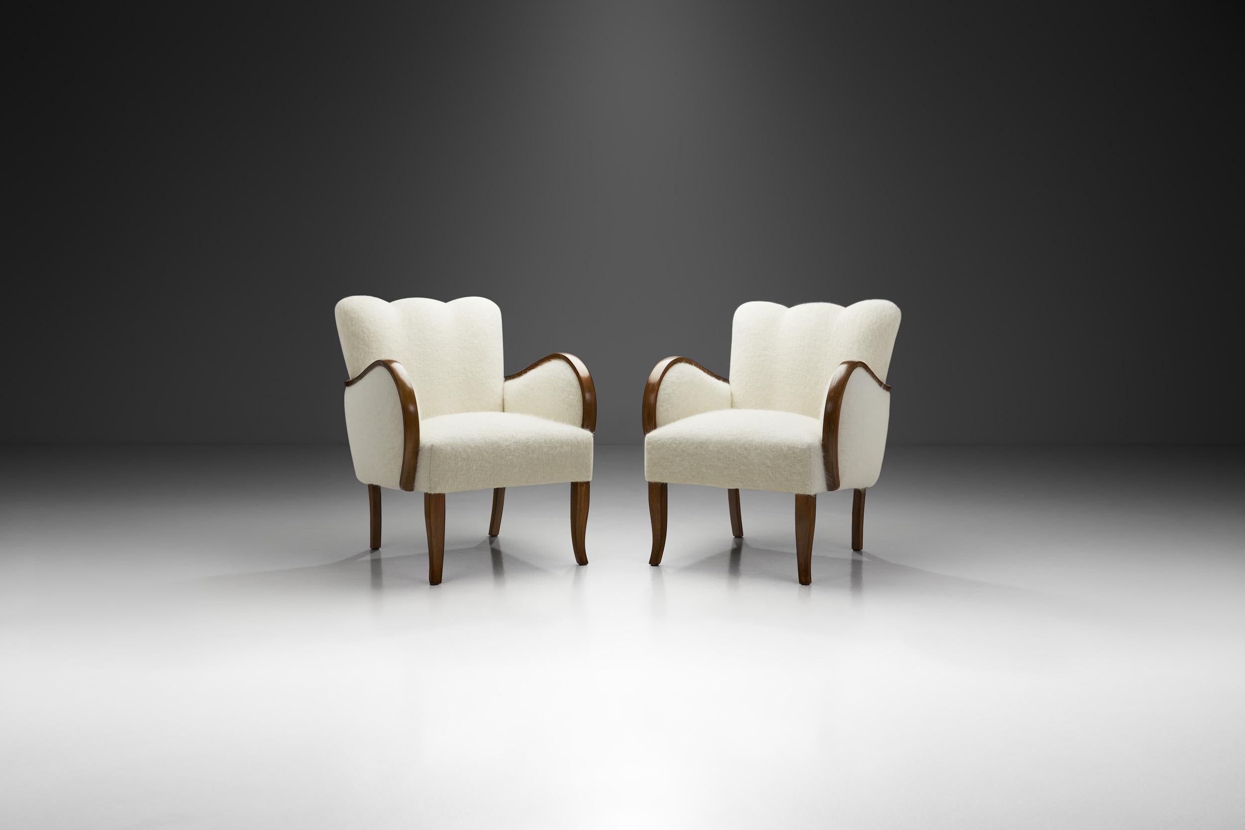 Simplicity, functionality, and elegance - these are the basic aspects of Danish design and, accordingly, of this pair of sophisticated easy chairs. The design dating from the early mid-century era, shows qualities of both Danish Art Deco and