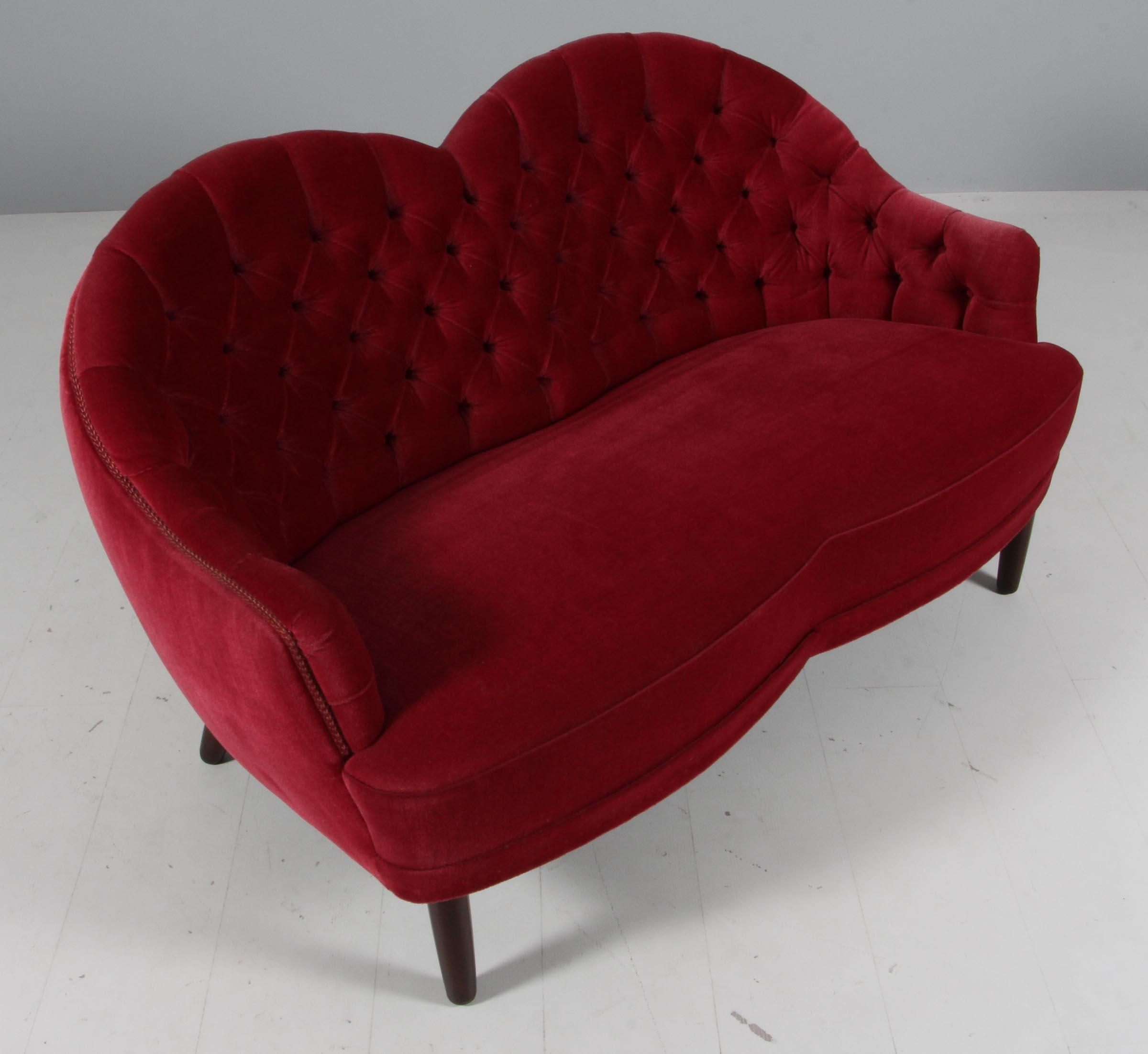 Danish cabinetmaket small loveseat sofa with red velvet with buttons.

Legs of stained beech.