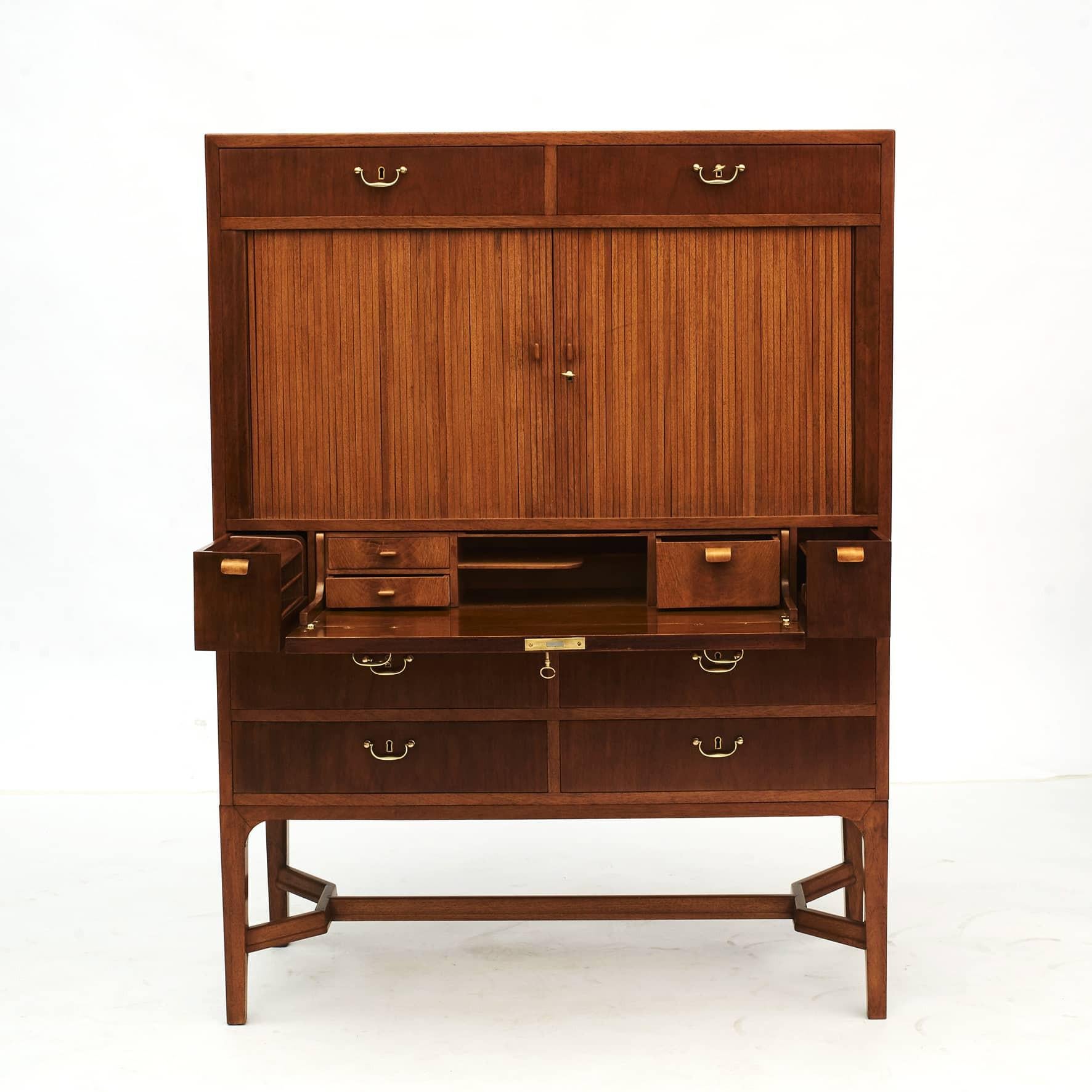 Made in the 1950s by Danish cabinetmaker this unique custom-made cabinet features double tambour doors with interior shelves, drawers and a fold-out writing plate, great for a laptop.
Crafted in light and dark mahogany. Interior made in maple.
A