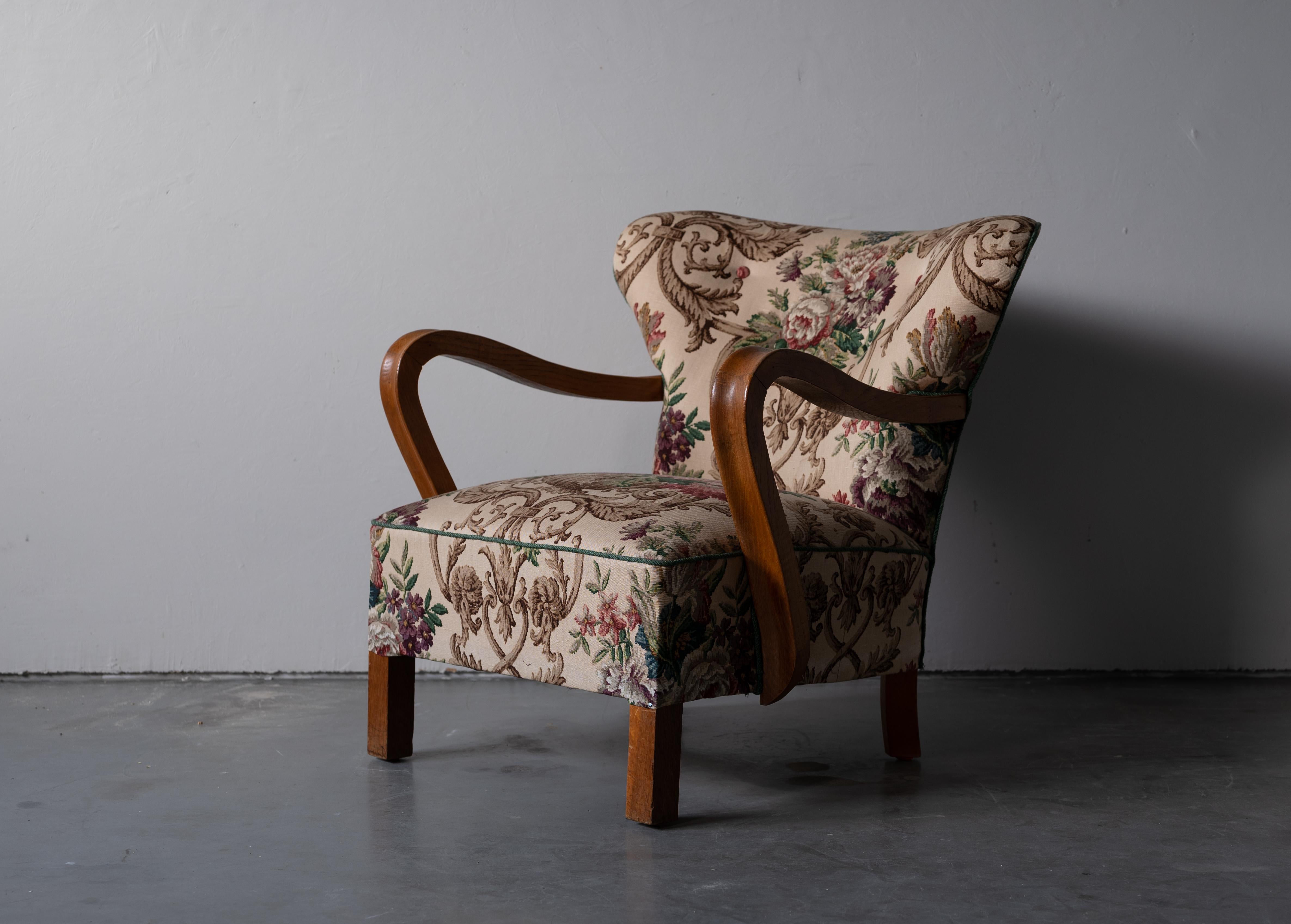 An organic lounge chair, designed and produced in Denmark, 1940s. 

Stained beech, vintage floral upholstery.

Other designers of the period include Jean Royère, Gio Ponti, Flemming Lassen, Philip Arctander, and Arnold Madsen.