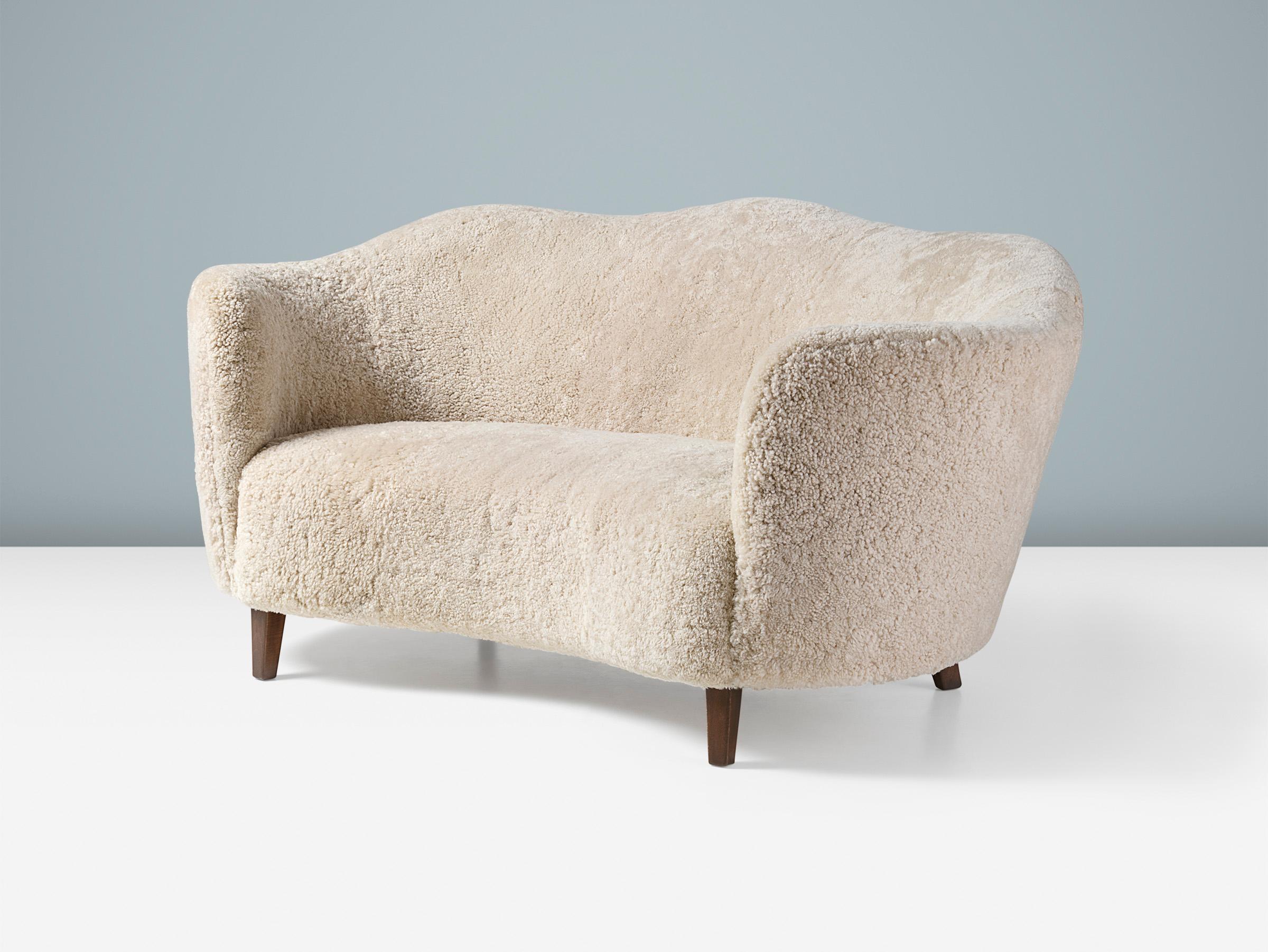 Ce canapé 2 places de forme unique, fabriqué par un ébéniste danois dans les années 1940, a un dossier en forme de feston et des accoudoirs enveloppants. Il est également doté d'une assise légèrement incurvée et a été entièrement remis à neuf dans