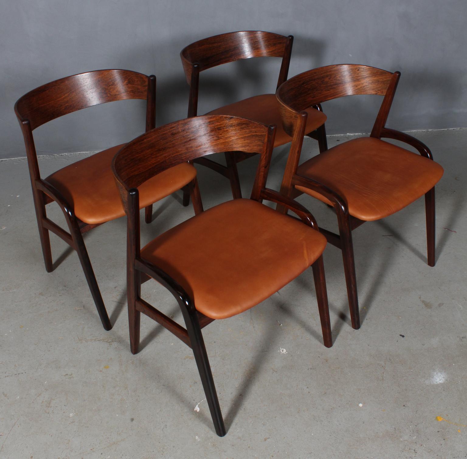 Danish cabinetmaker set of four chairs in rosewood. 

Seats new upholstered with vintage tan aniline leather.

Made in the 1960s.