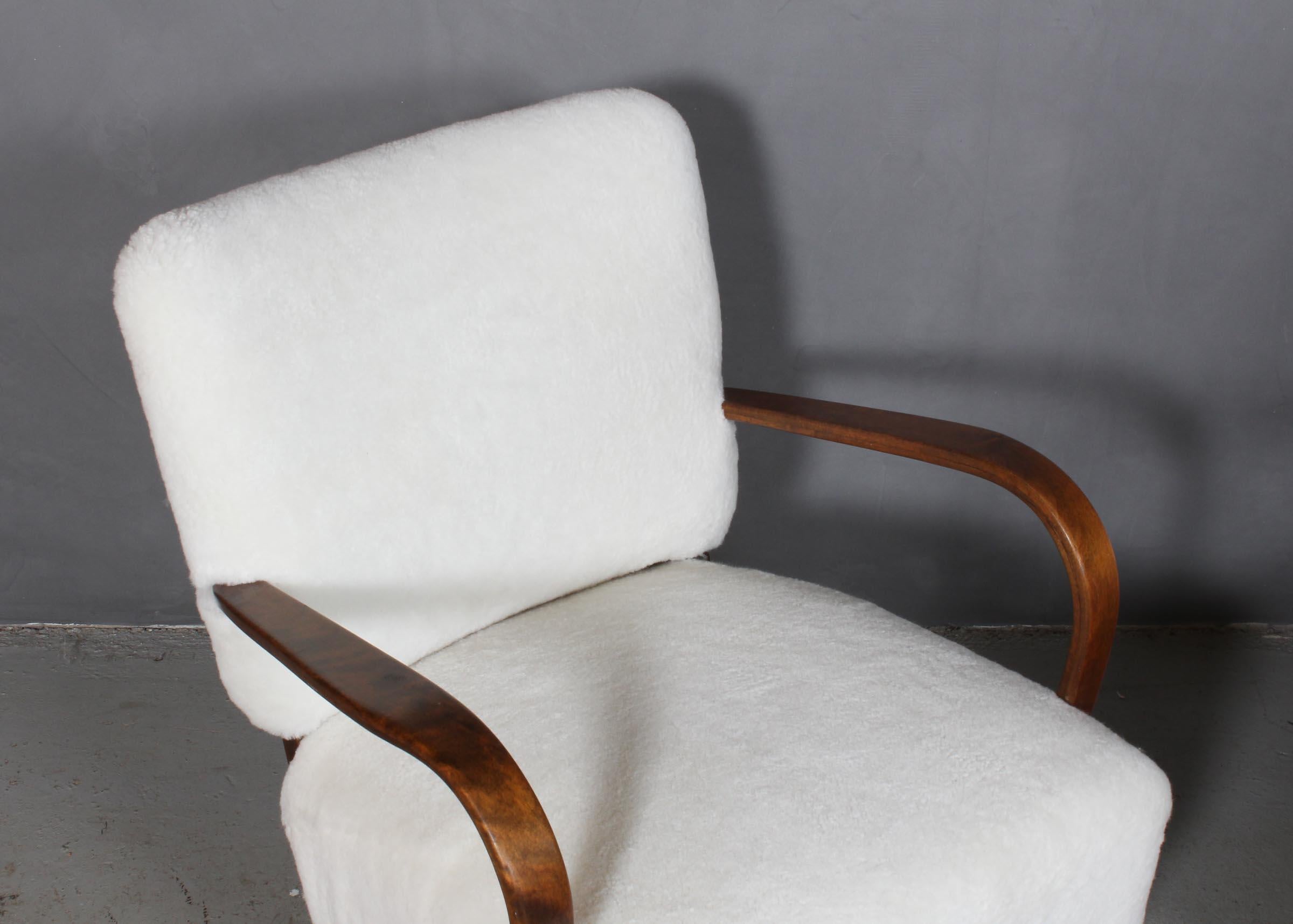 Danish cabinetmaker set of lounge chairs new upholstered with lambskin.

Legs and armrests of stained beech.

Made in the 1940s.

