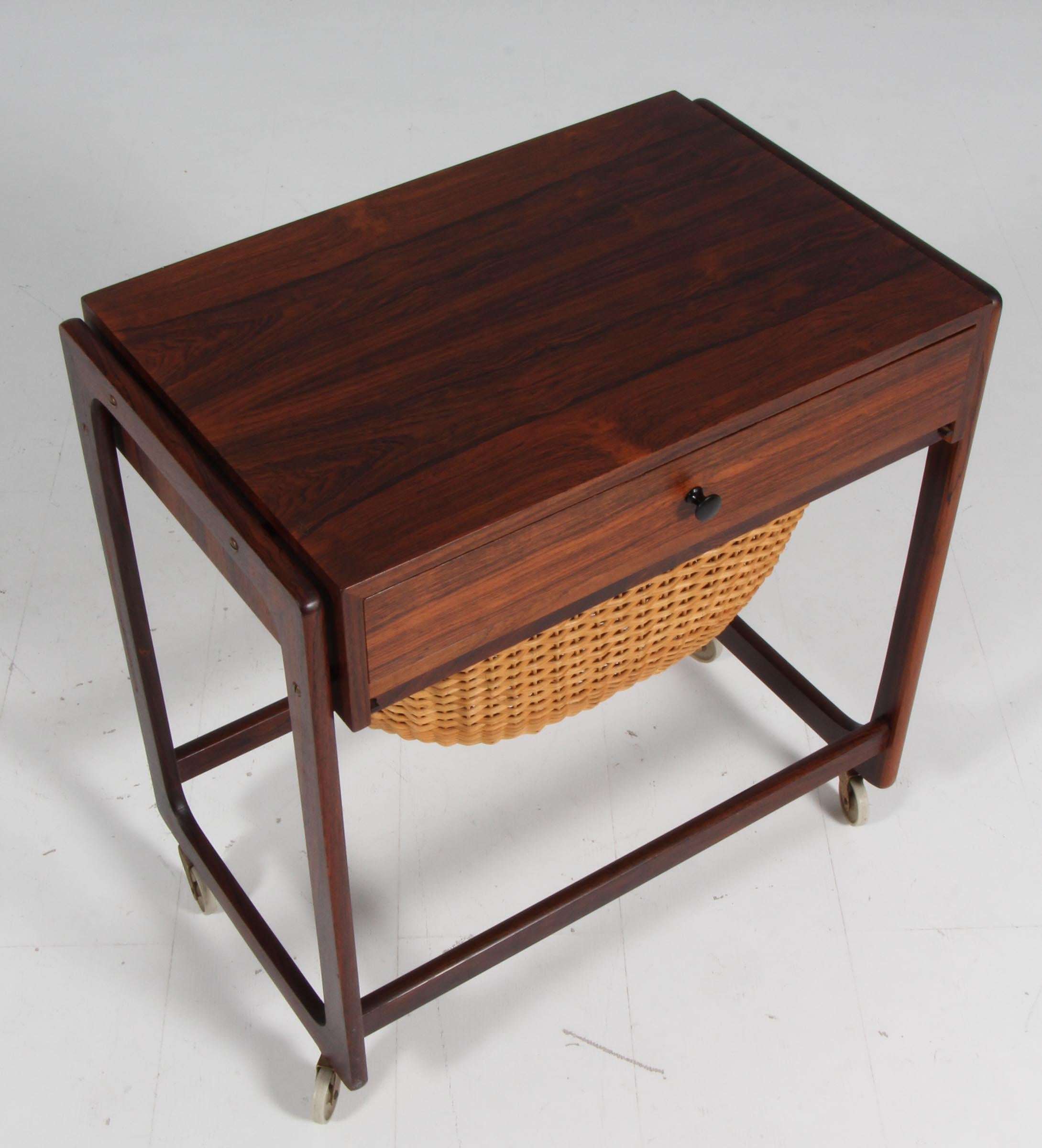 Danish cabinetmaker sewing nest in rosewood. One drawer and one in cane.

On wheels.