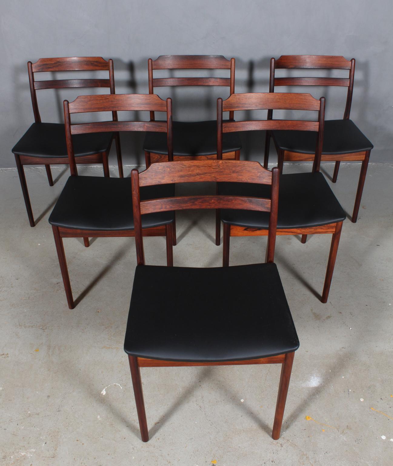 Danish cabinetmaker. Six rosewood dining chairs.

New upholstered with black leather.