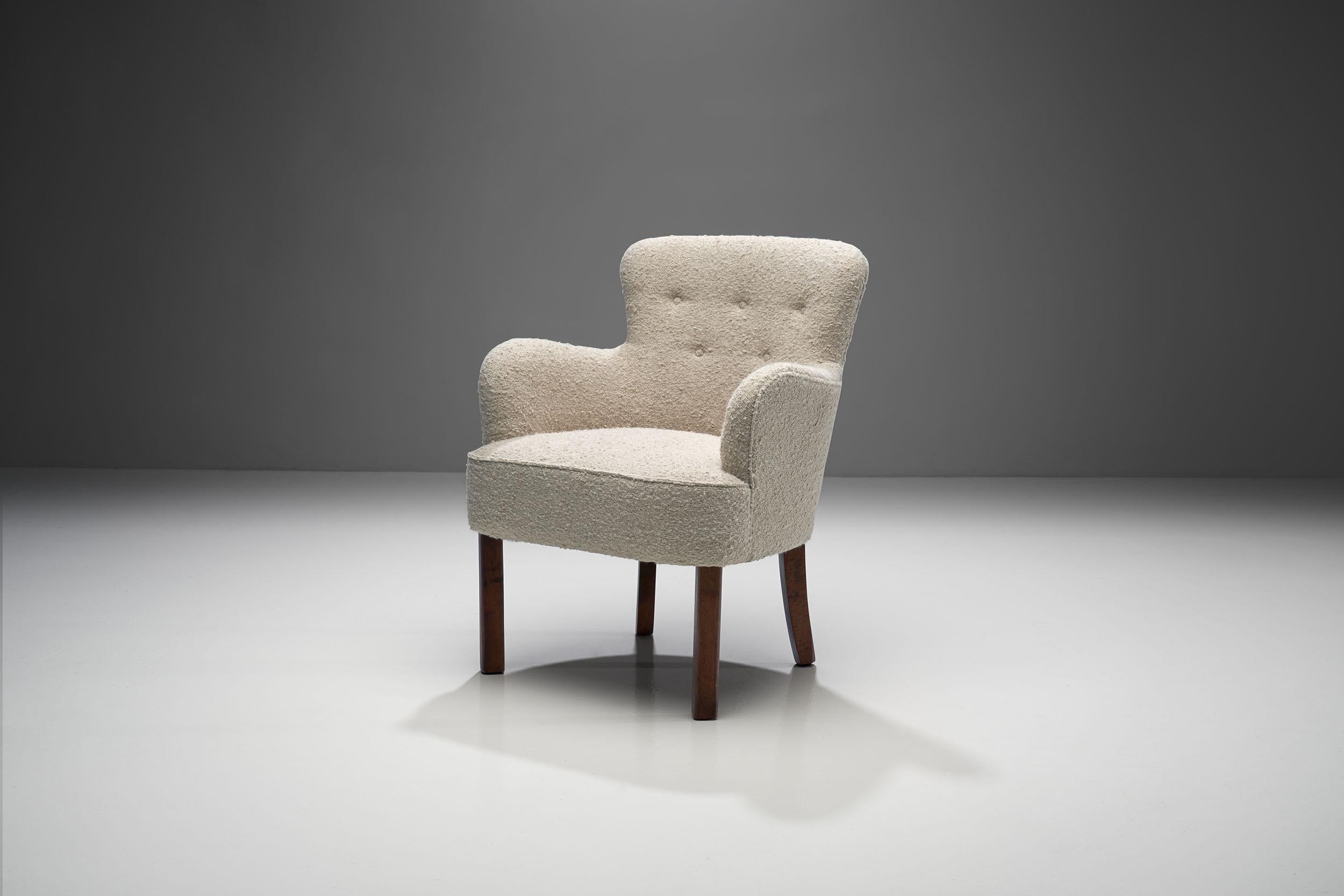 Small wool and oak midcentury armchair by a Danish cabinet maker.

This stylish chair demonstrates why midcentury Danish design is so popular to this day. With its rounded edges, cozy wool upholstery, and soft colors, this chair is ideal to blend