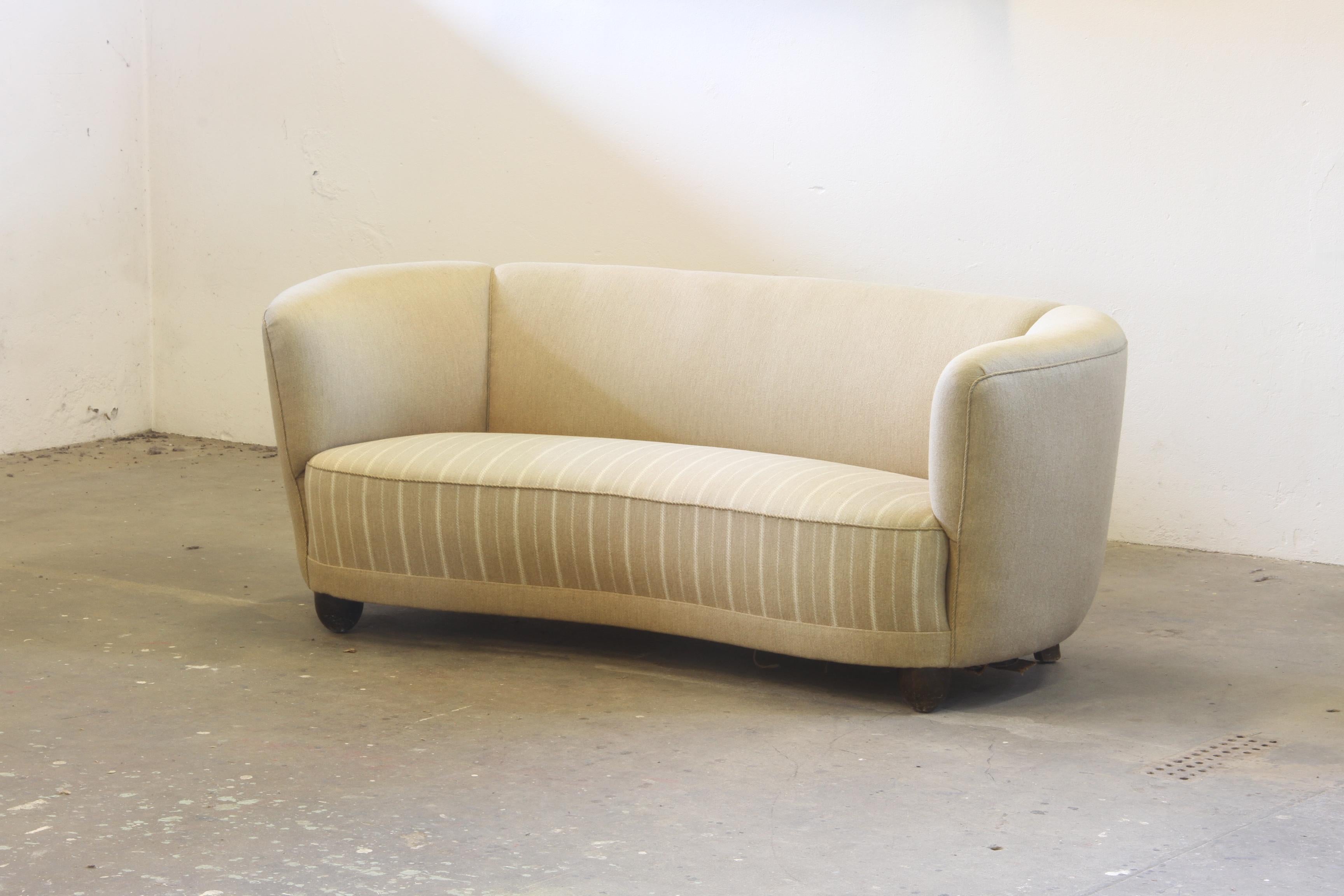 This beautiful banana-shaped sofa is a true testament to Danish craftsmanship from the mid-20th century. Built in the 1930s or 1940s by an unknown cabinetmaker, it is heavy, strong, and robust—constructed to last for generations. The frame is made