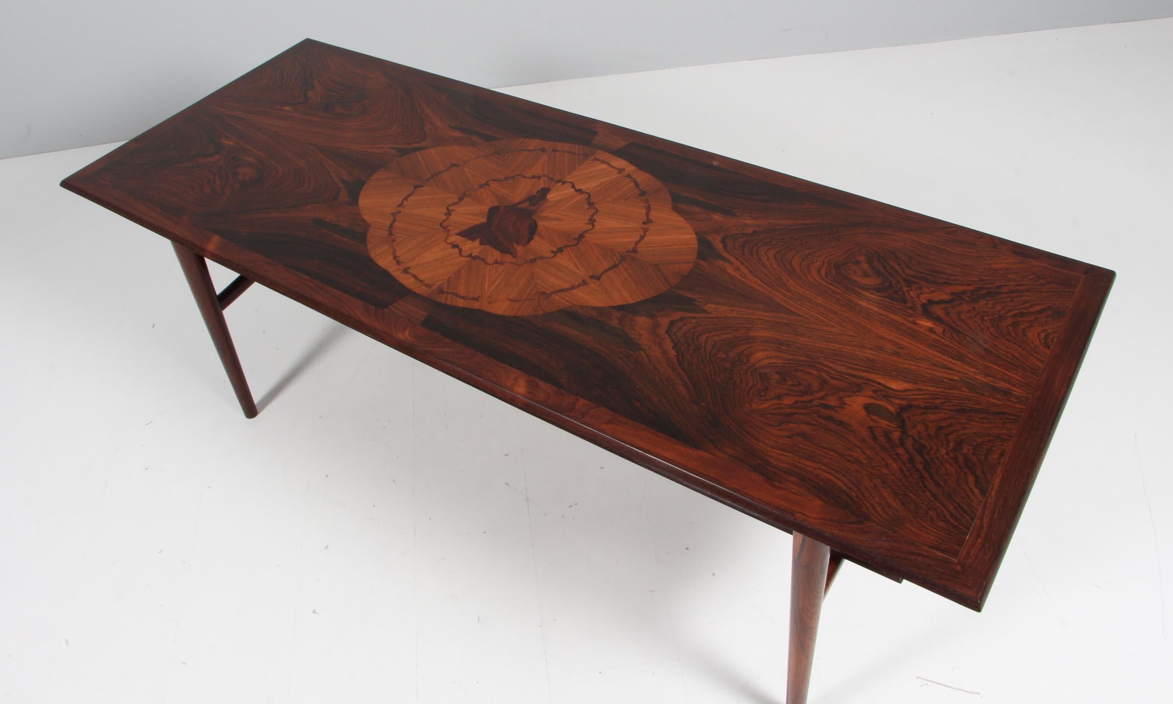 Danish Cabinetmaker sofa table in rosewood with intarsia work of the famous little mermaid.

Made in the 1950s.