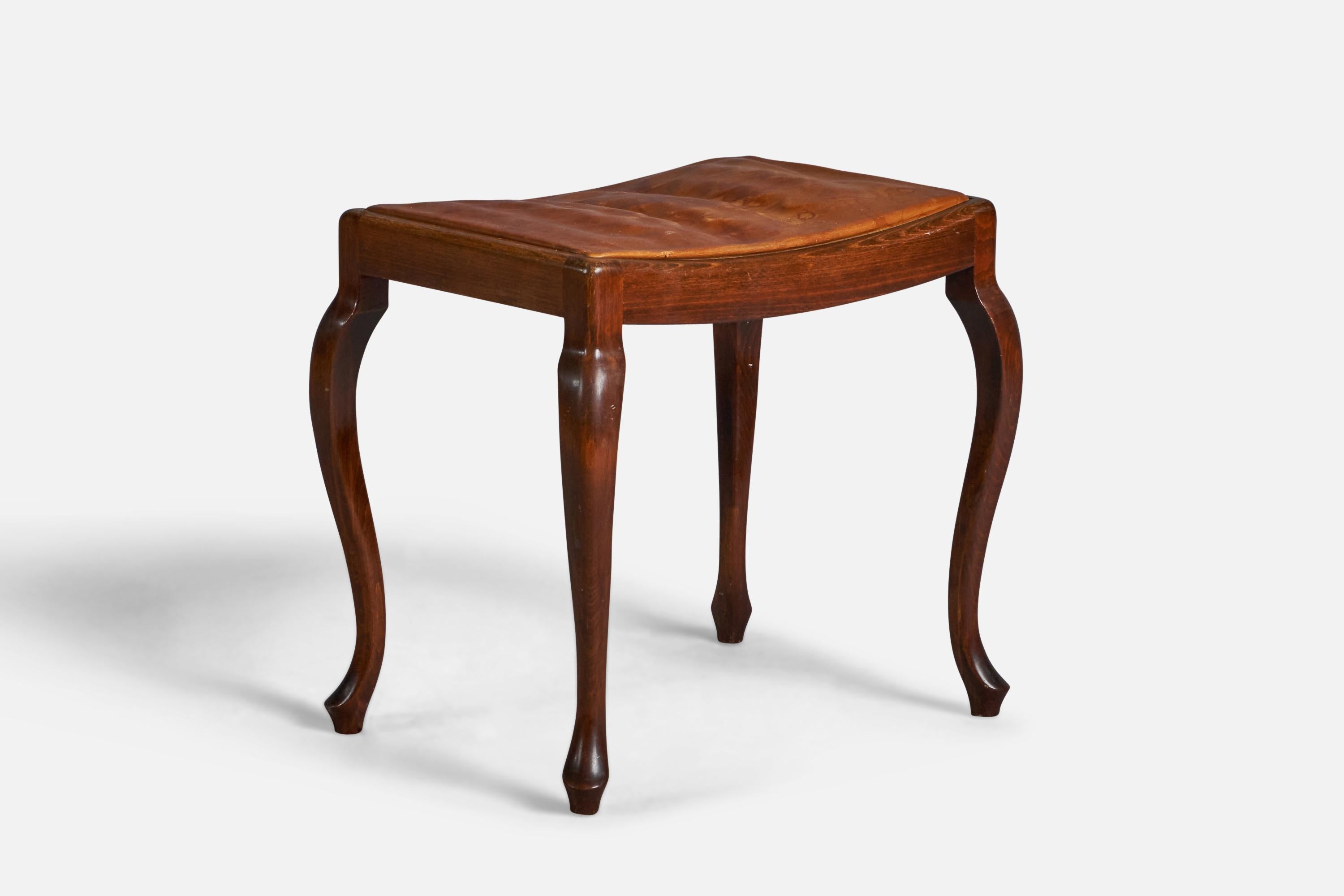 A solid mahogany and natural brown leather stool, designed and produced in Denmark, 1940s.