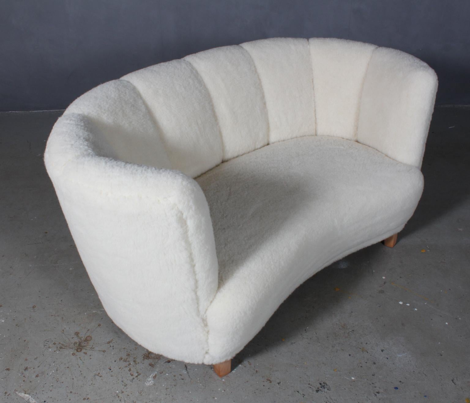Danish cabinetmaker two-seat sofa new upholstered with lambwool.

Legs of beech

Made in the 1940s.
