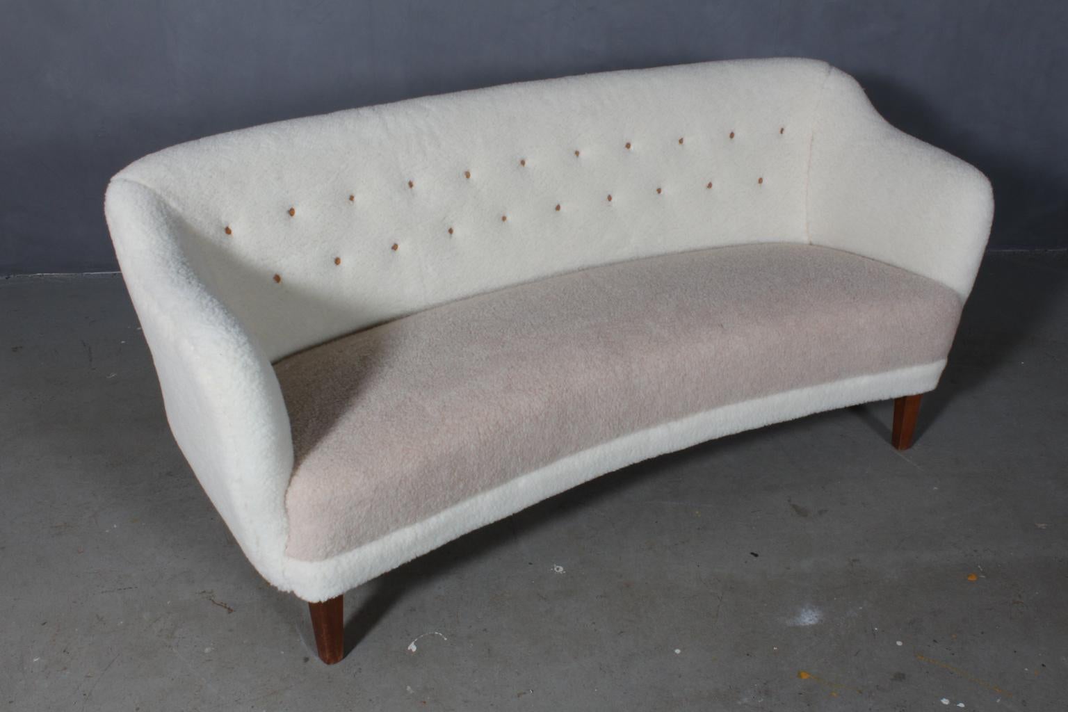 Danish cabinetmaker two½-seat sofa new upholstered with two-tone lambwool. Leather buttons.

Legs of stained beech

Made in the 1940s.