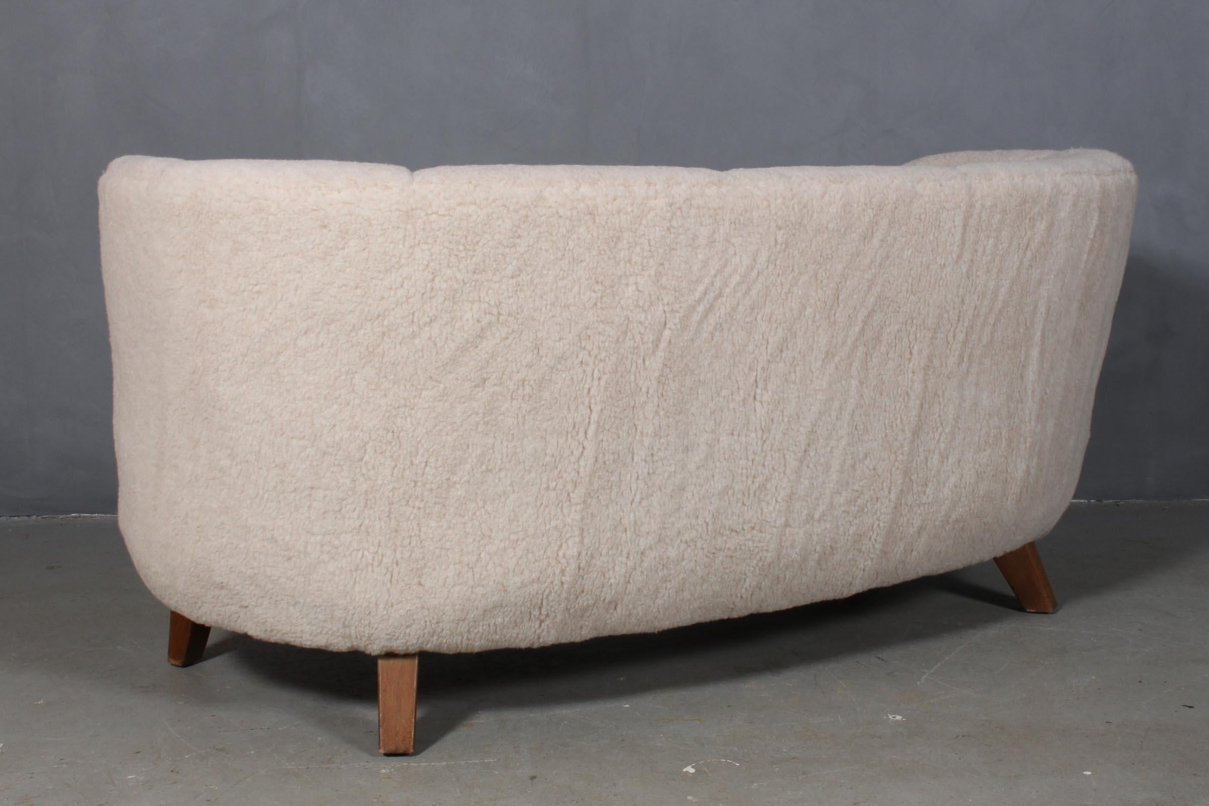 Danish cabinetmaker two-seat sofa new upholstered with lambwool.

Legs of beech

Made in the 1940s.