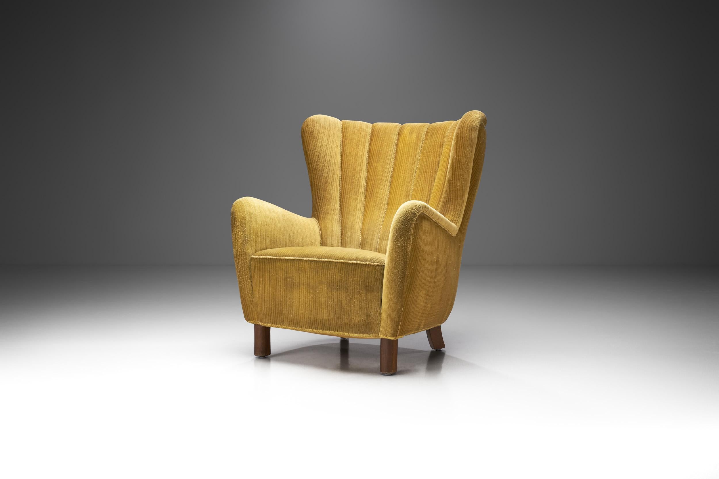 This unique 1940s winged easy chair is a great representation of the quality and craftsmanship of Danish master cabinetmakers and the immediately recognizable characteristics of Scandinavian design. The design of this model is in favour of the user,