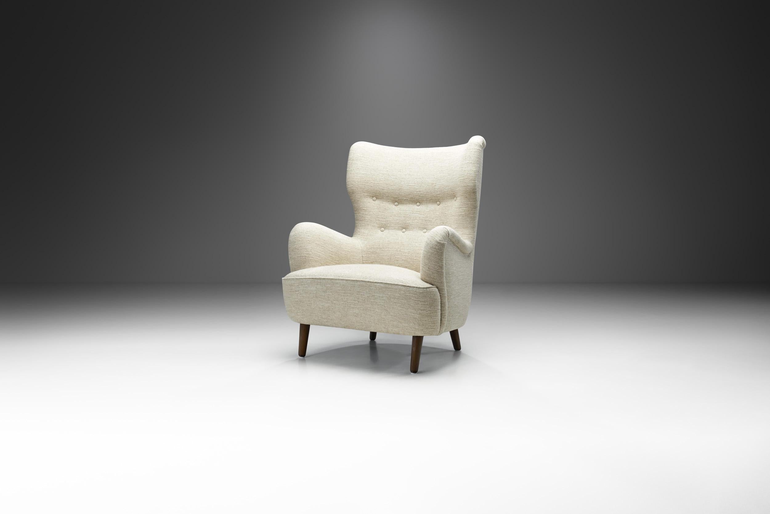 Danish mid-century design is known for clean and pure lines that coupled craftsmanship with delicate research into proportions, materials and the requirements of the human body, adapting design to modern-day needs. This wingback chair is a prime and