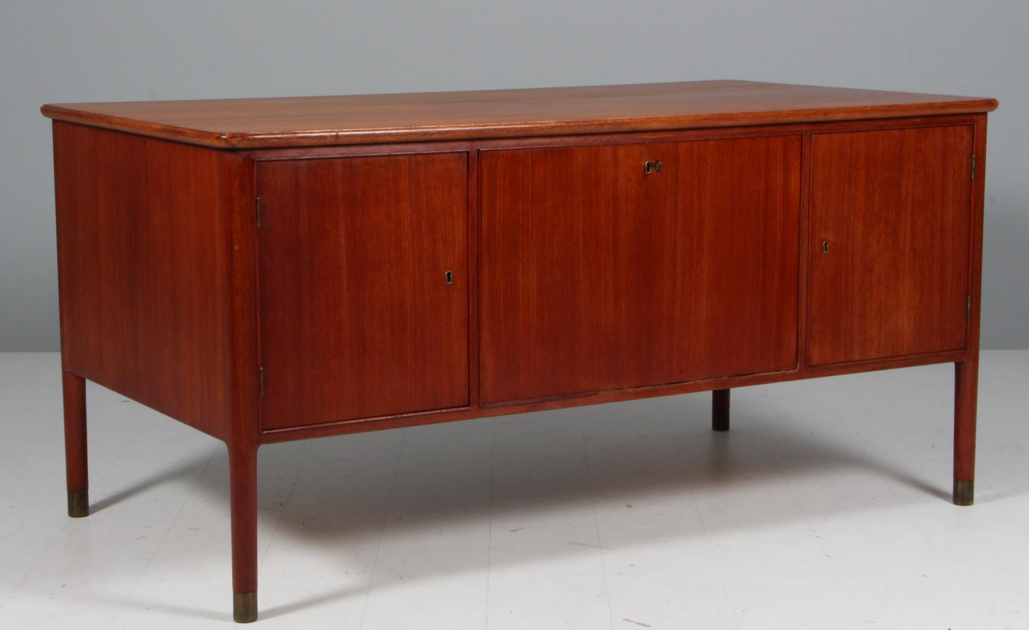 Danish cabinetmaker writing desk in mahogany. With handles and legs in brass.