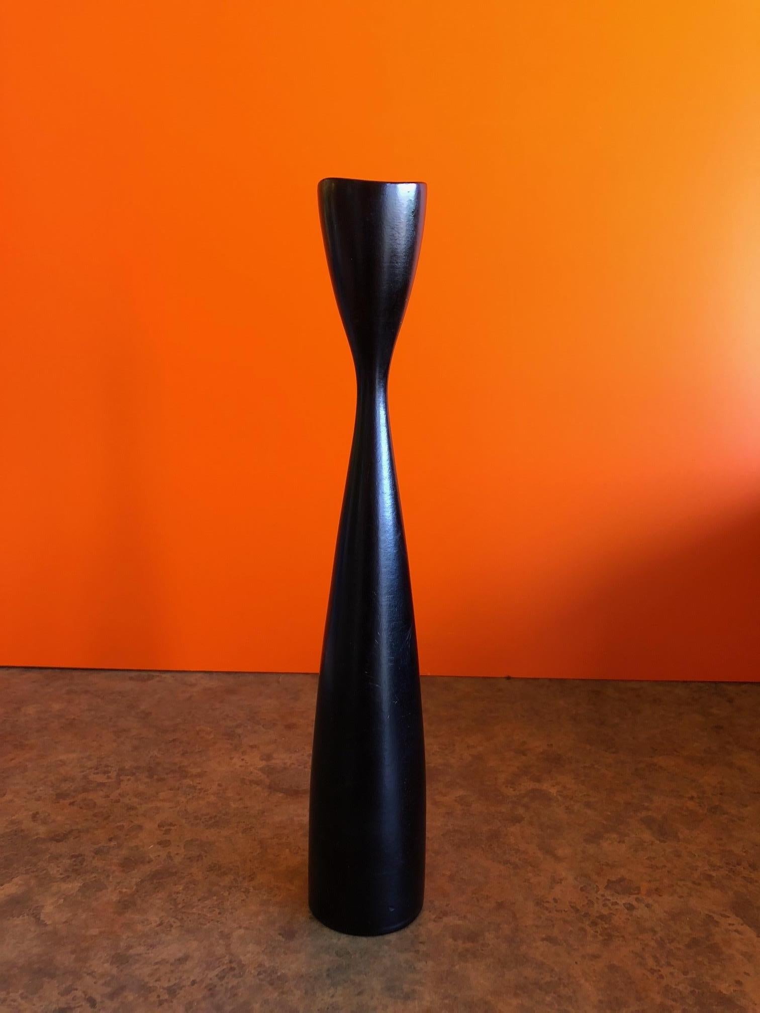 A single and elegant Danish wood candlestick, circa 1960s. The piece is 11