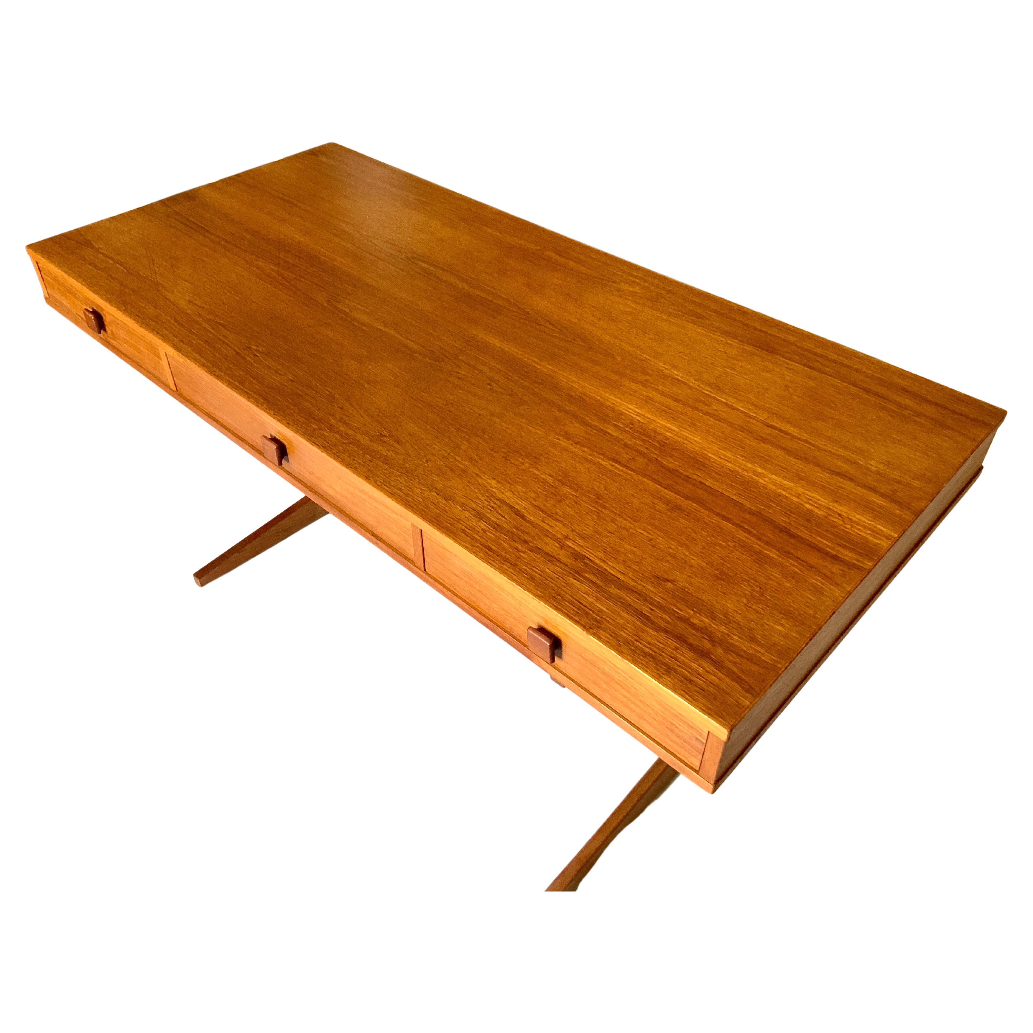 Cantilever desk designed by Georg Petersens for Georg Petersens Mobelfabrik in Denmark. Circa 1960s beautiful teak wood. Unique architectural designed sturdy desk top accompanied by 3 drawers with sculpted square pulls. Desk appears to be floating