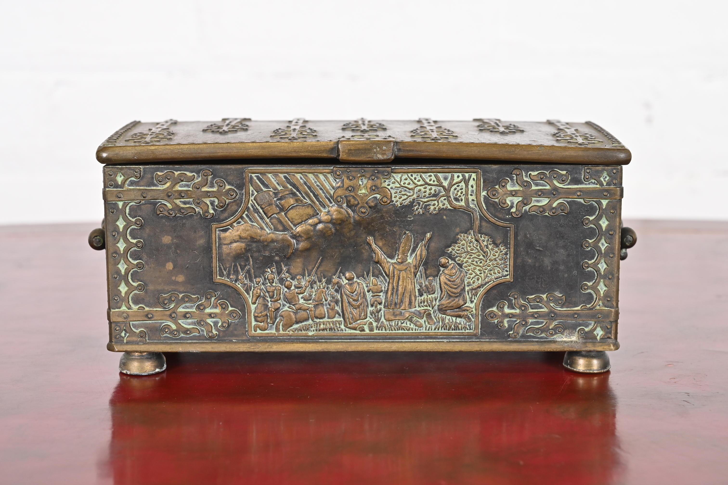 A beautiful casket form cast iron and bronze dresser box, jewelry box, cigar box, or decorative box with interior cedar lining. The front depicts a scene from the 1219 Battle of Lyndanisse, during the Estonian Crusade of King Valdemar II of