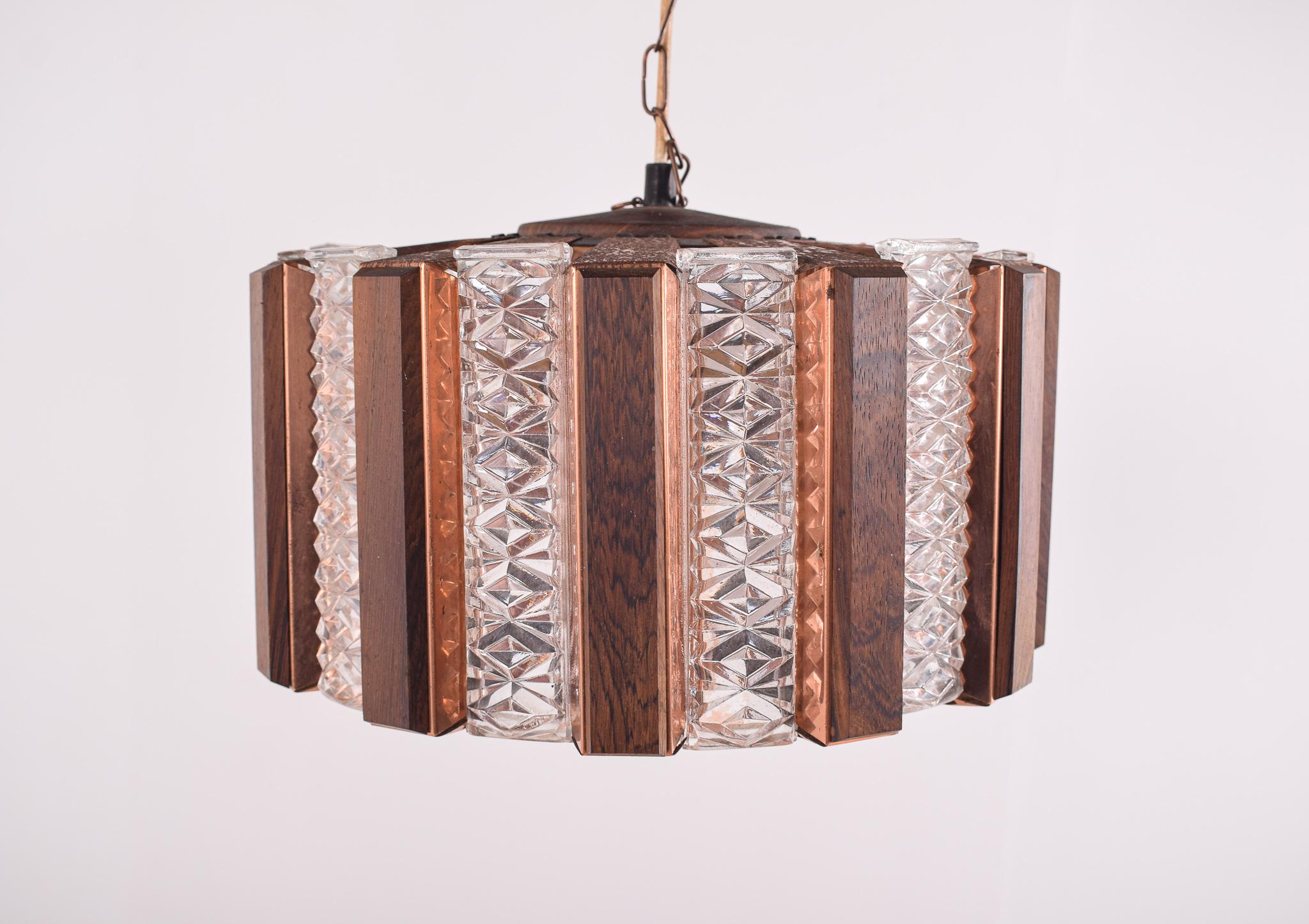 Scandinavian Modern ceiling lamp in brass, glass and teak. Round with alternating yellow and amber colored glass bricks and wooden slats mounted on brass plates. Lamp is suspended in a brass chain, which can be shortened is desired. Emits a warm and