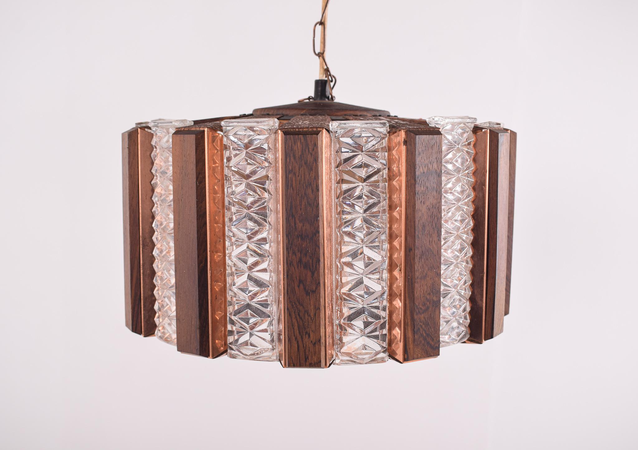 Scandinavian Modern ceiling lamp in brass, glass and teak. Round with alternating yellow and amber colored glass bricks and wooden slats mounted on brass plates. Lamp is suspended in a brass chain, which can be shortened is desired. Emits a warm and