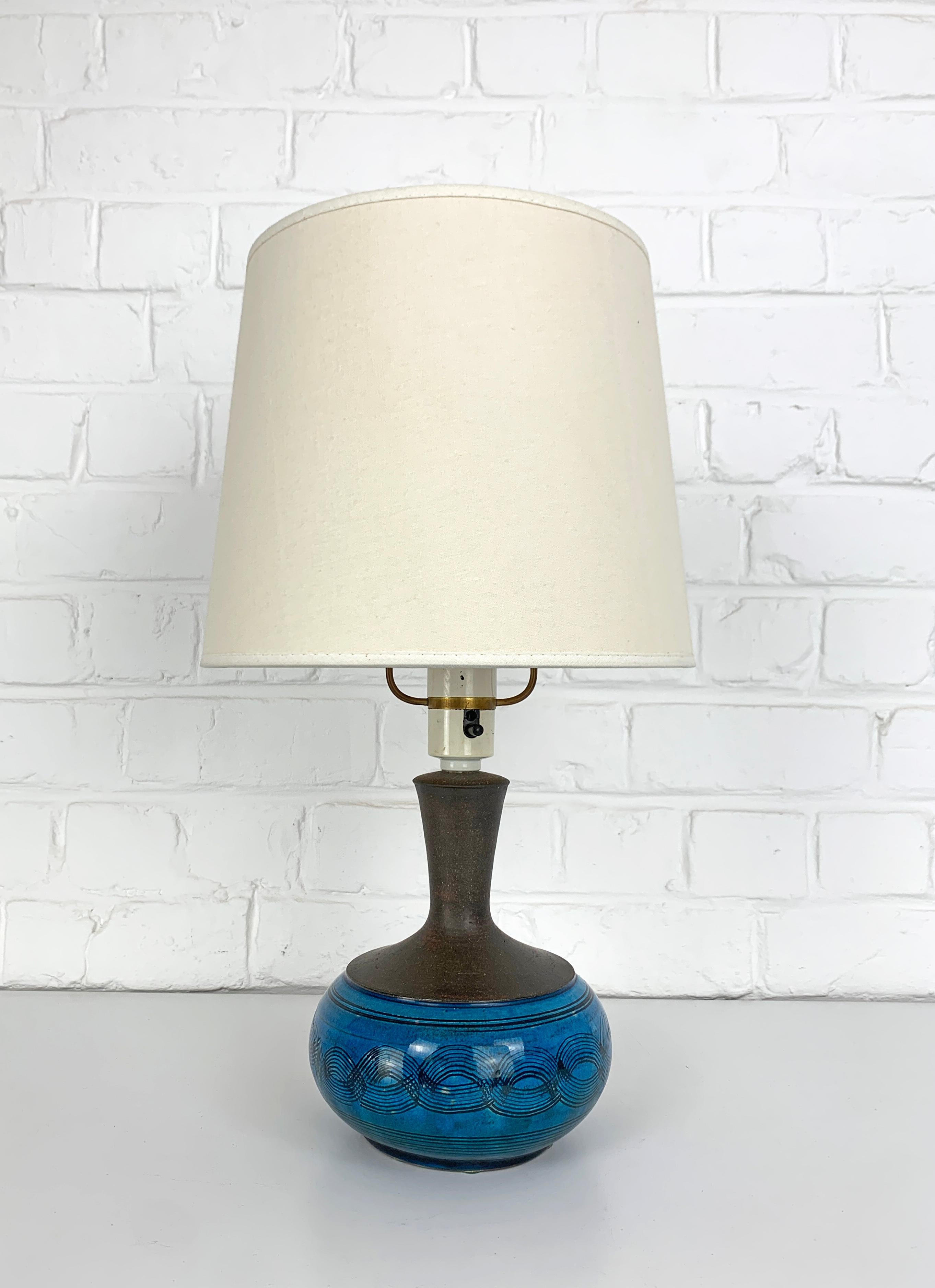 Stoneware table lamp in blue glaze and brown natural stoneware finish. Designed by Nils Kähler in the 1960s or 1970s. 

Manufactured in the workshop of Herman A. Kähler Ceramic (HAK) in the town of Naestved in southern Denmark.

Nils Kähler was the