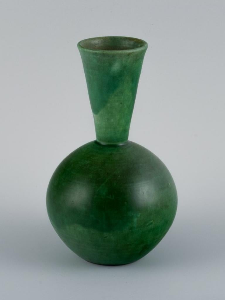 Danish ceramicist, handmade vase with glaze in green tones.
Mid-20th century.
In perfect condition.
Dimensions: H 18.5 x D 10.5 cm.