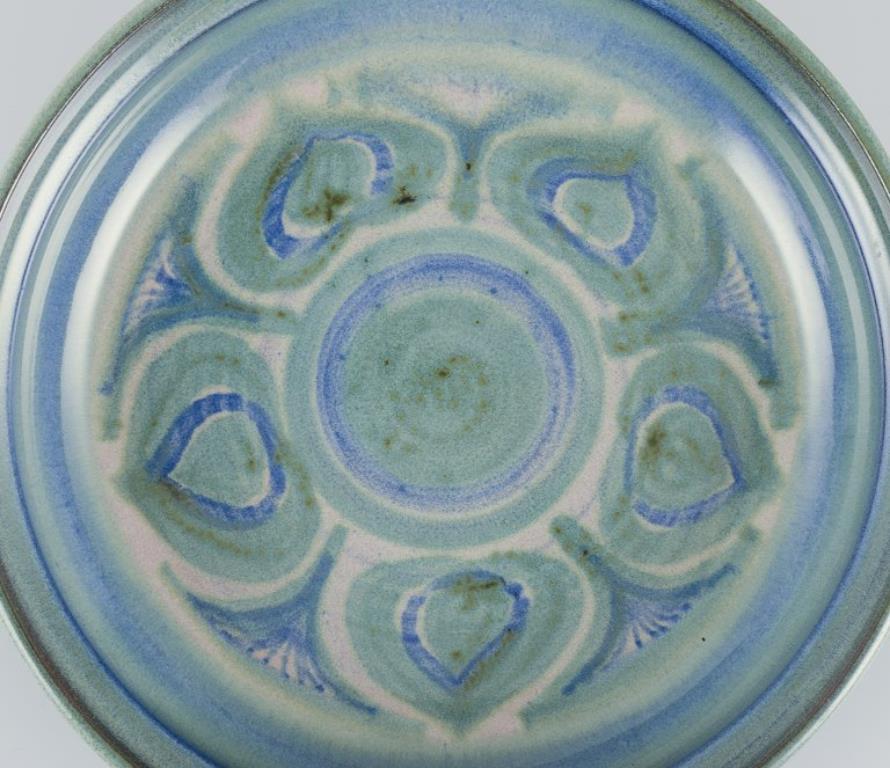 Scandinavian Modern Danish ceramicist. Large ceramic bowl. Glaze in blue and green tones. For Sale