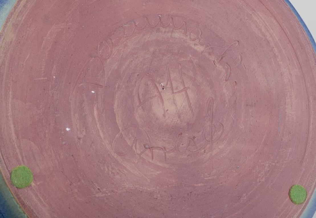 Late 20th Century Danish ceramicist. Large ceramic bowl. Glaze in blue and green tones. For Sale