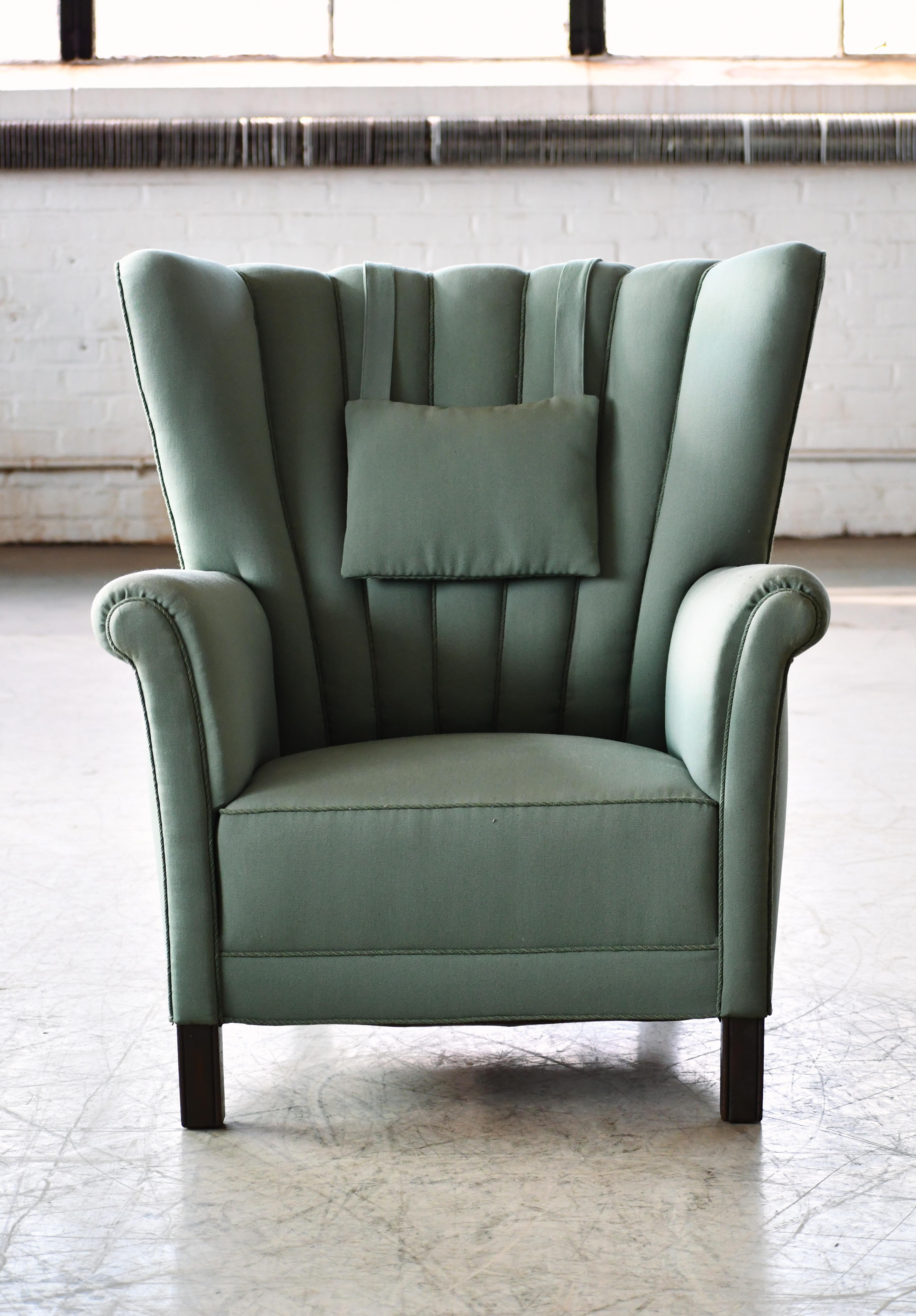 Sublime medium size club chair reminiscent of Fritz Hansen's famous model 1518 and likely made in the late around 1950 judging from the leg design and the slimmer armrests. The chair is unmarked and we are not aware of the Designer/Maker but since
