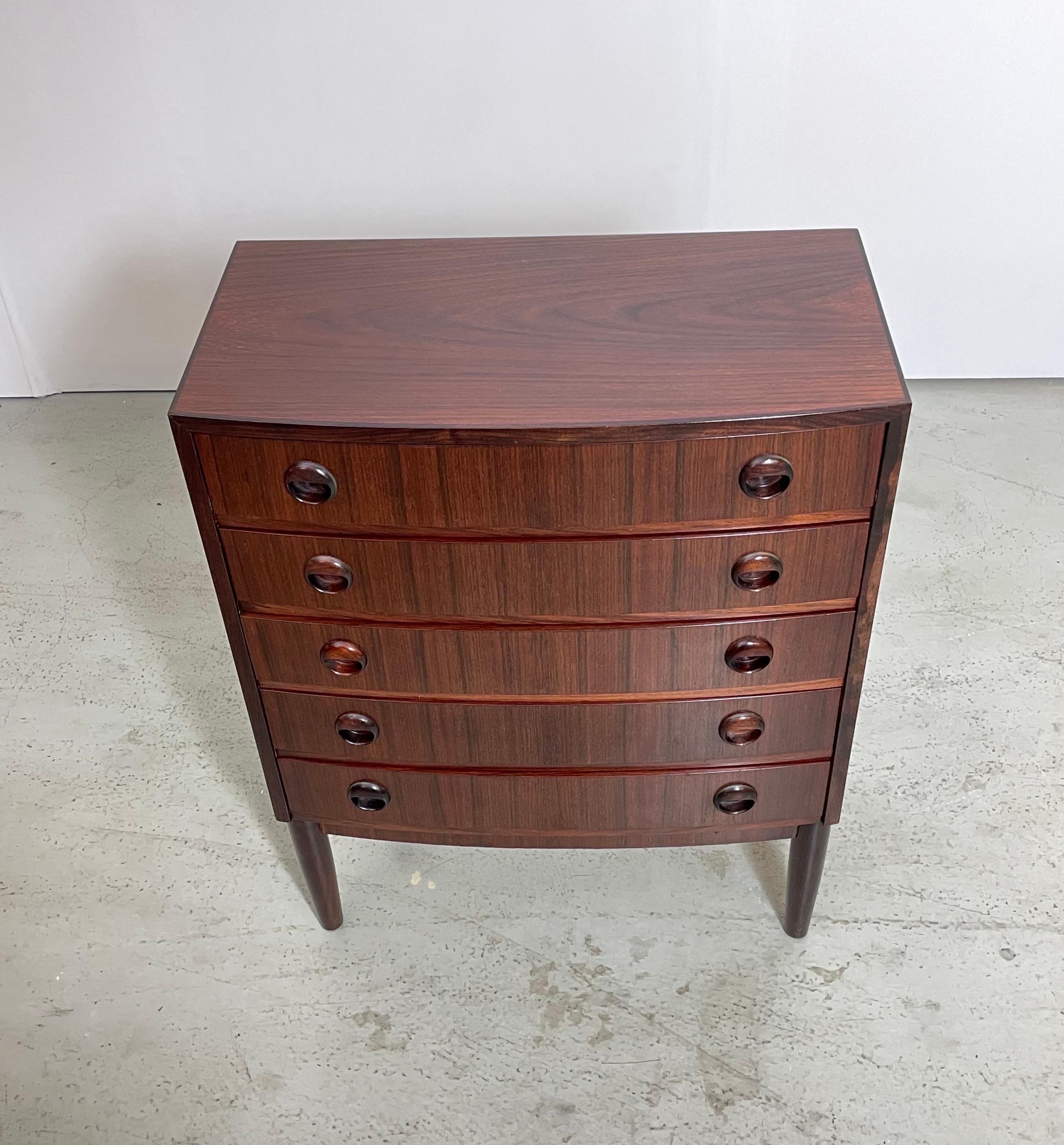 Mid-century chest of drawers designed by Kai Kristiansen. It was produced in Denmark during the 1960's. This is a rare piece made of rosewood which shows a remarkable wood grain. The high-quality craftsmanship is notable in the details such as the