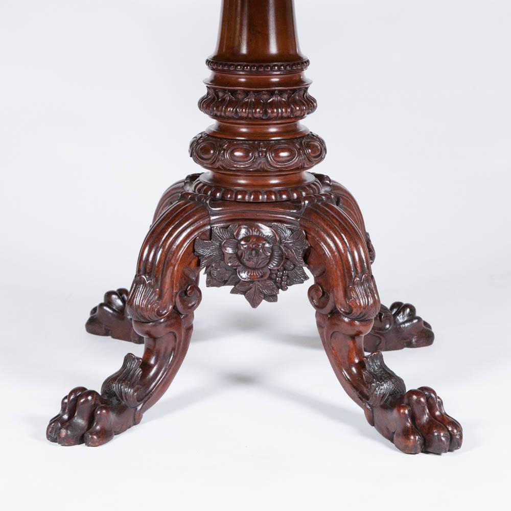 A mahogany circular centre table with finely carved base and apron, Danish, circa 1870.

 