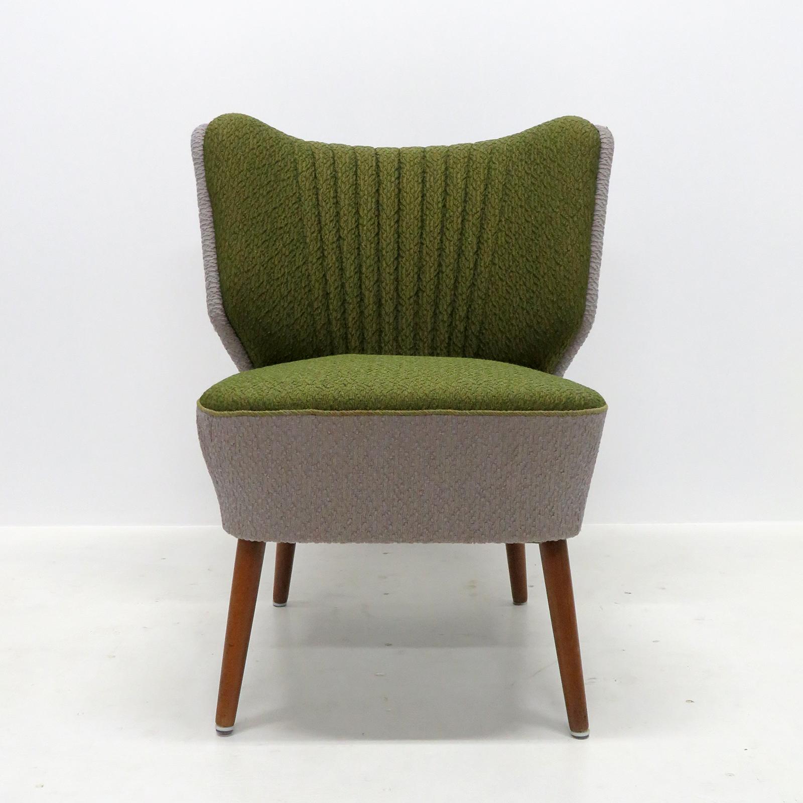 Wonderfully elegant original Danish cocktail chair from 1950, with original spring supported seat cushions and riveted edge details on teak legs in great condition, the multi-colored upholstery looks to be from a later date.