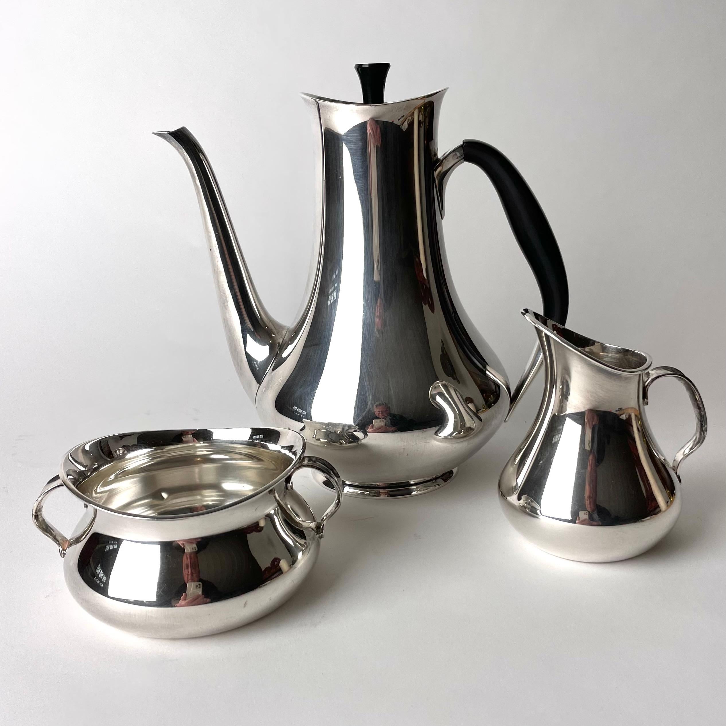 Very elegant Danish Coffee set of three parts in Silver by Hans Bunde (1919-1996) for Cohr. Designed in 1958 and with Danish and Swedish control stamps for silver. 

Dimensions:
20*19*13 cm
6*12*10 cm
10*9*7 cm

Minor marks and dents exist (see
