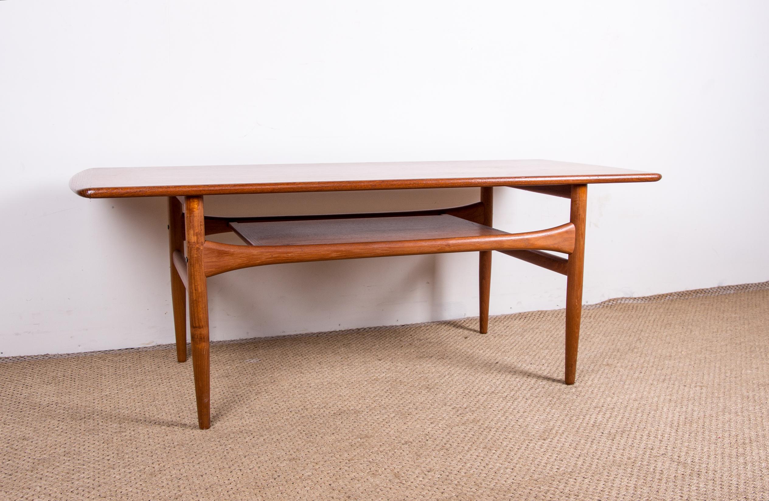 Beautiful Scandinavian coffee table. It has a wooden lower level for more storage. Very elegant aerial design, tapered legs, curved top across the width. Very good build quality.