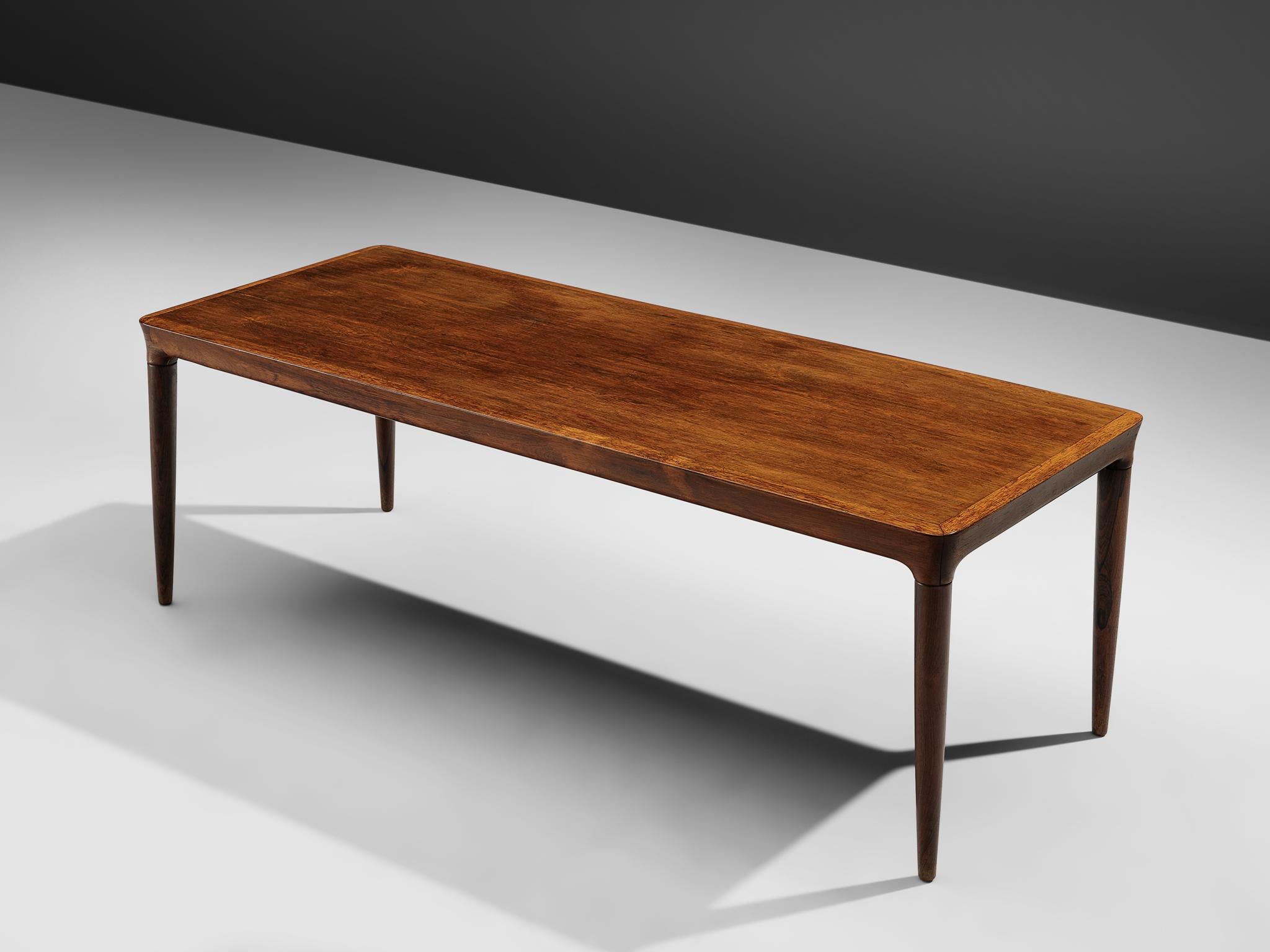 Coffee table, rosewood, Denmark, 1960s

Rectangular coffee or side table in rosewood, the tabletop shows beautifully grained rosewood finer. The rounded edges and tapered legs give this Danish side table an elegant and timeless look. An excellent