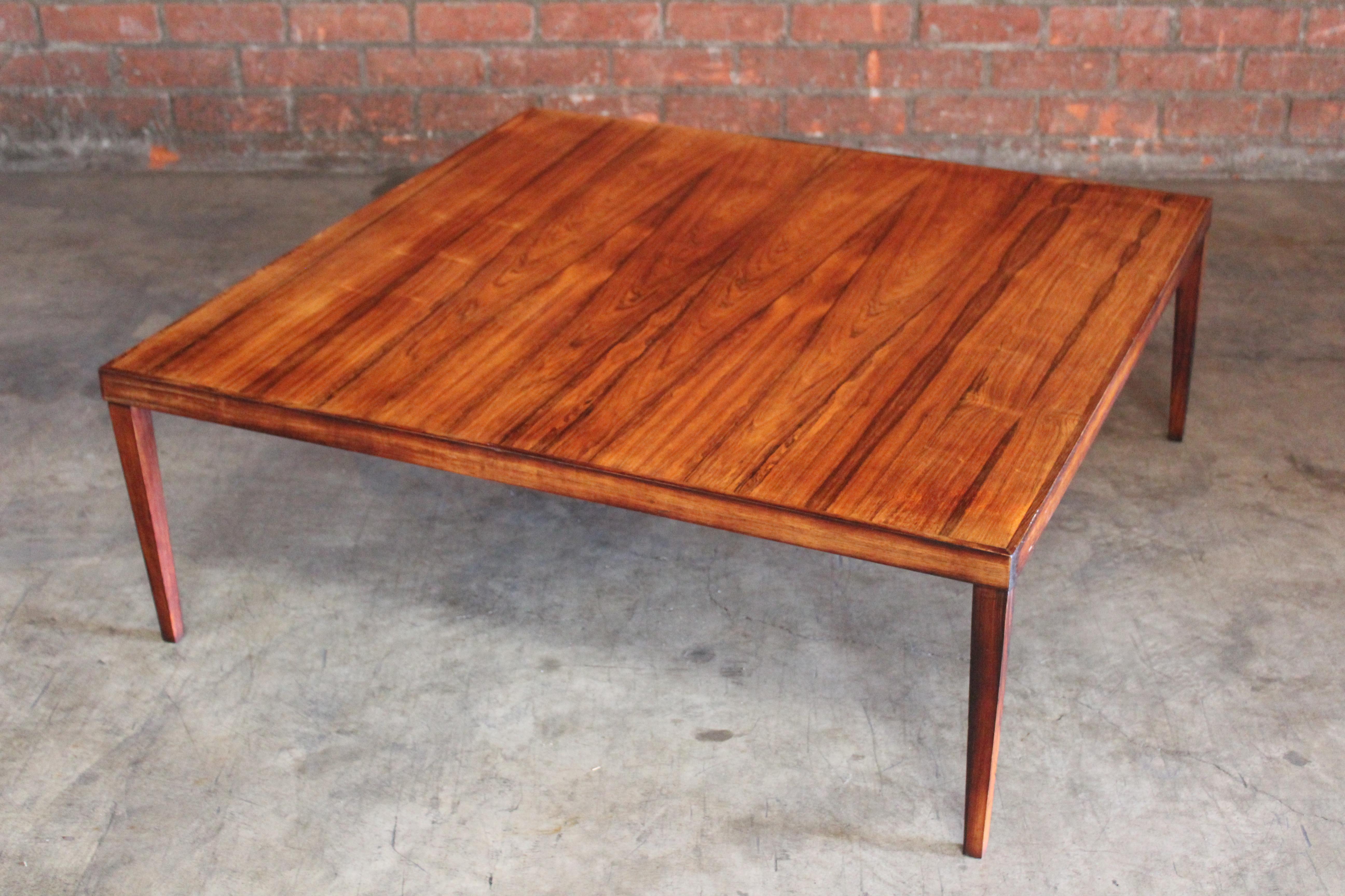 A vintage 1960s Danish coffee table in Brazilian rosewood. In good original condition with some wear. Minor fading on the surface and some veneer loss on the corner.