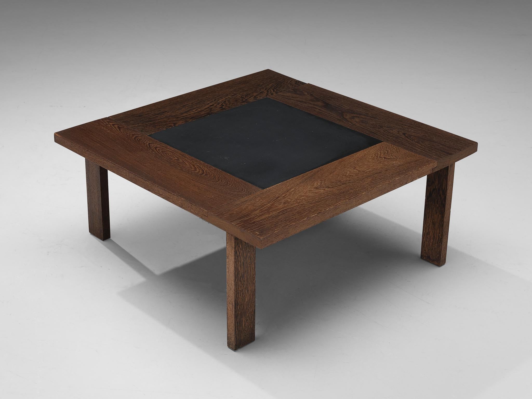 Coffee table, wengé, slate, Denmark, 1960s.

This modest, simplistic coffee table is very convincing to the eye by means of the implementation of natural materials. The wengé showcases an intricate warm deep wooden grain that gracefully surrounds