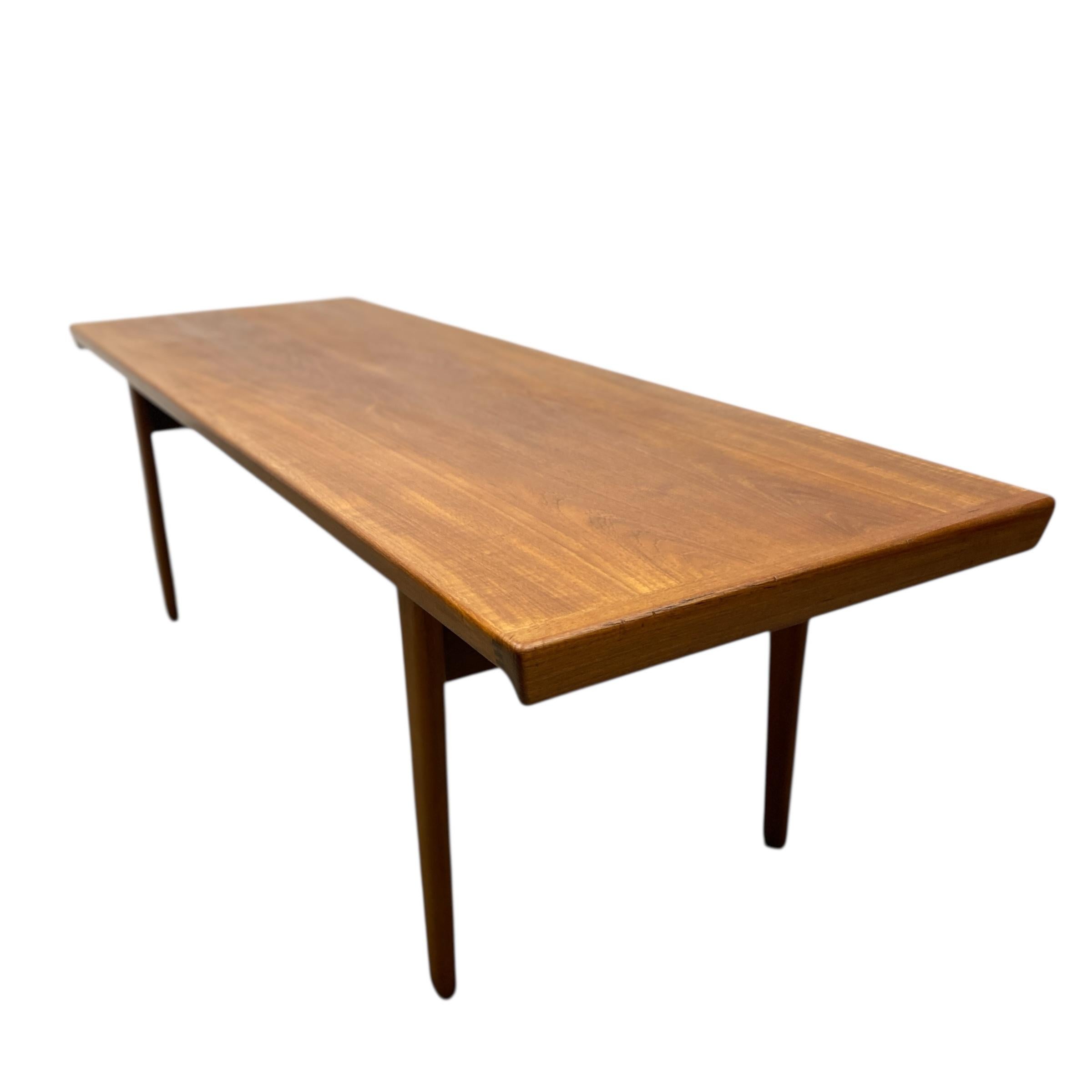 A superb midcentury Danish coffee table. The elegant 1960s coffee table is designed by Peter Hvidt & Orla Molgaard-Nielson & manufactured for France & Son. The teak has a beautiful golden brown colouring with an attractive grain. The coffee table