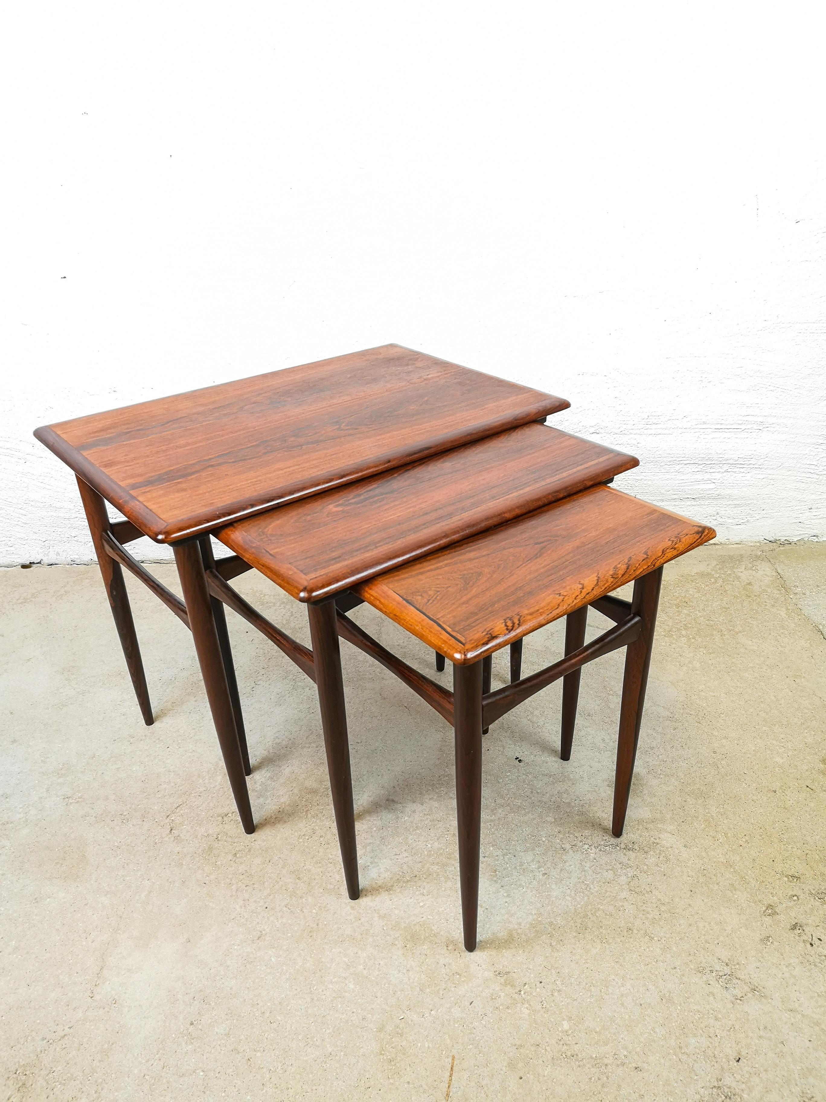 A set of 3 Kai Kristiansen midcentury rosewood coffee tables.

This set of three rosewood tables were designed by Kai Kristiansen and produced by Skovmand & Andersen circa 1960-1969. The tables are made of solid rosewood and teak with rosewood